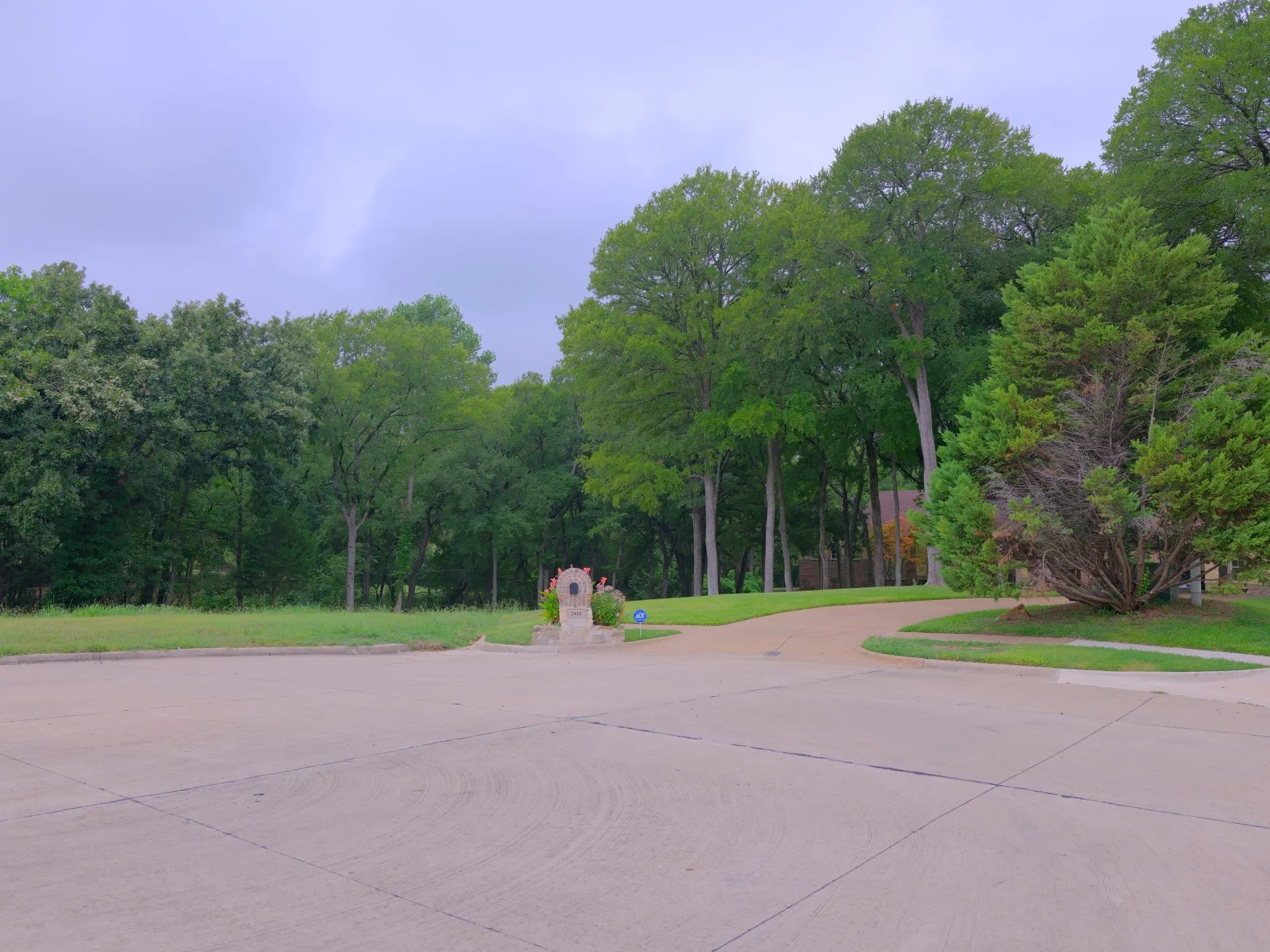 An angle stopping in front of the lot with the neighbors home right next to it as a reference point.