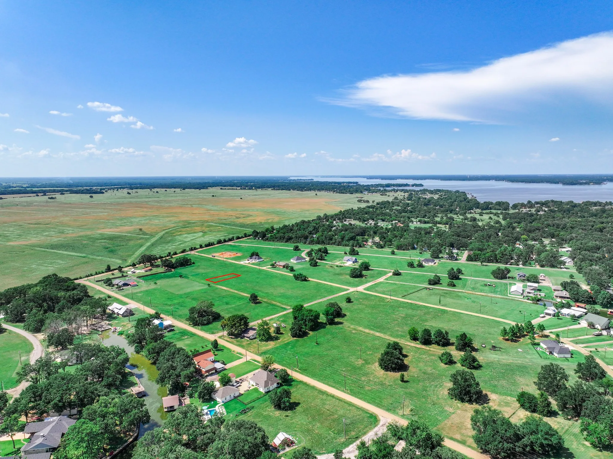 Aerial overview of property's location featuring rural landscape and a large body of water