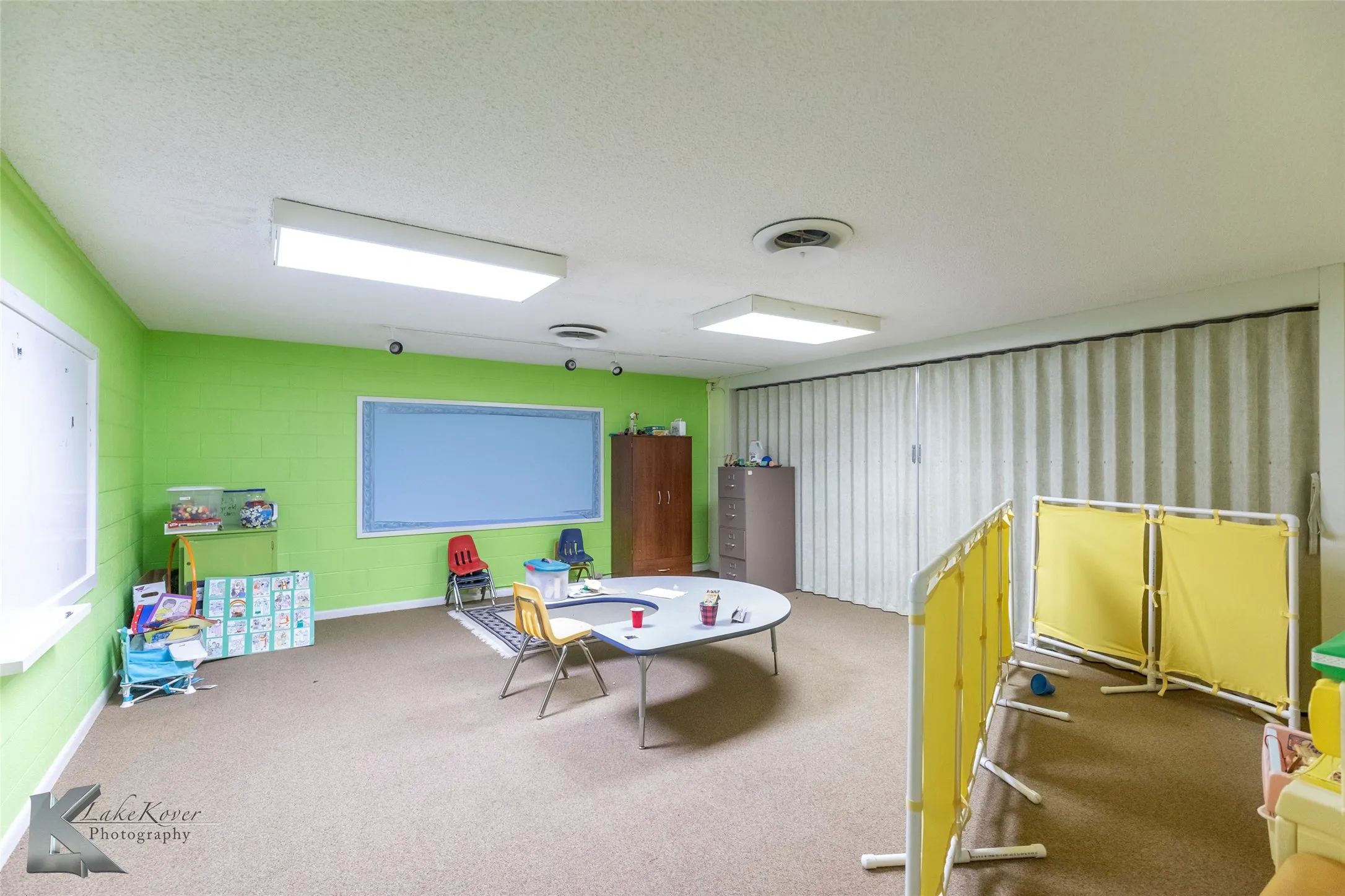 Recreation room with carpet and a textured ceiling