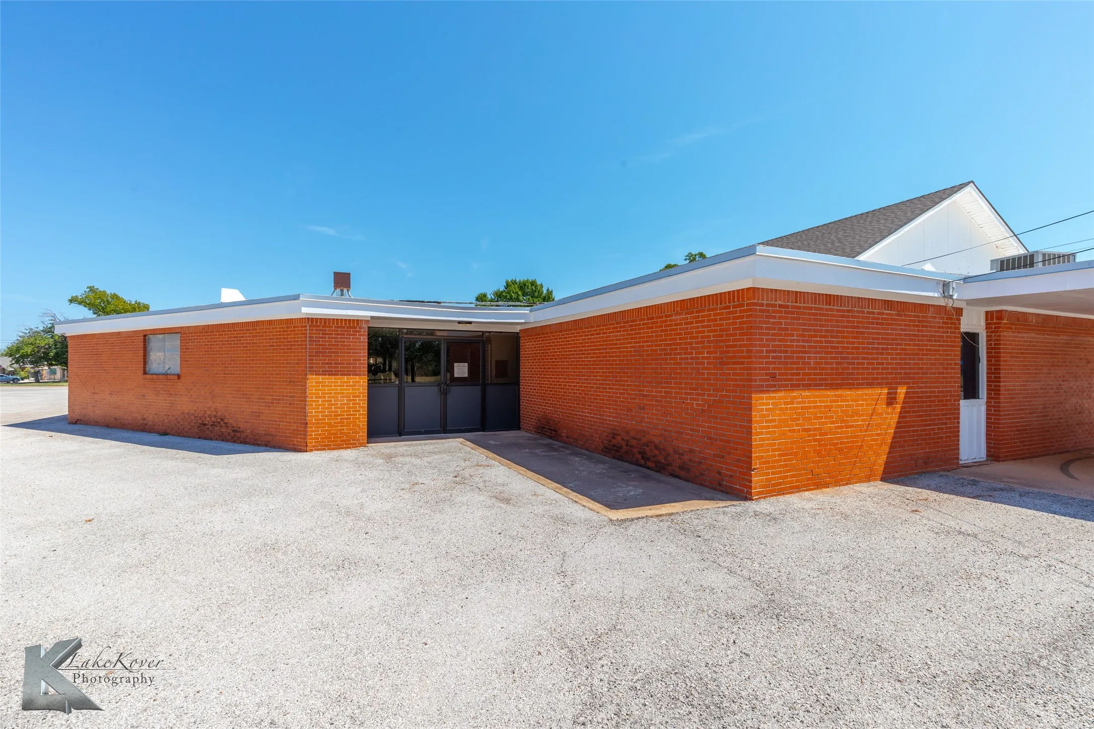 Rear view of property featuring brick siding