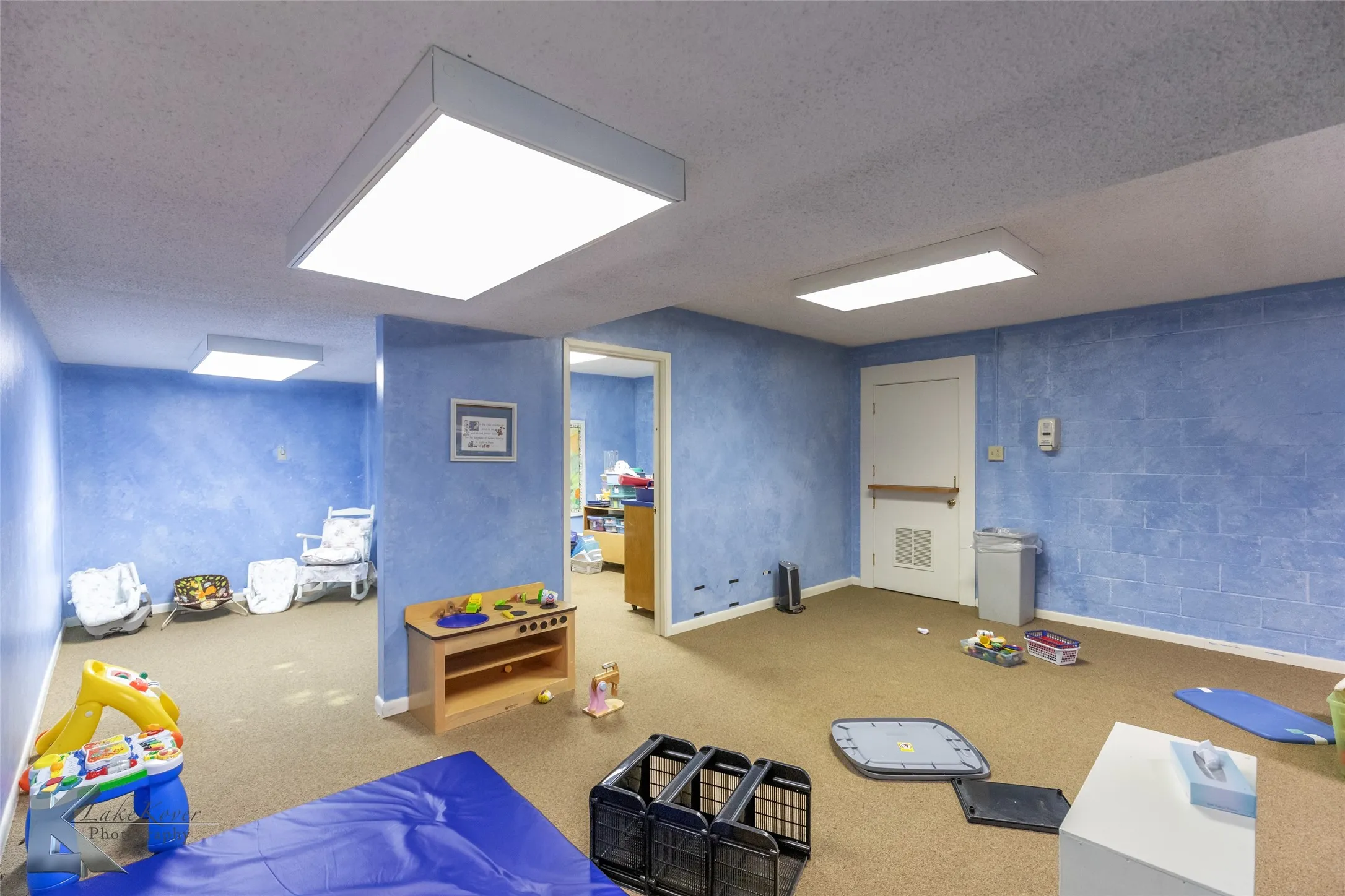 Rec room featuring carpet floors and a textured ceiling