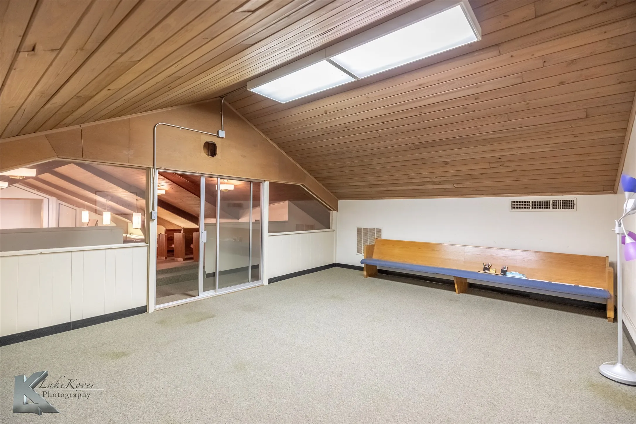 Bonus room with wood ceiling, vaulted ceiling, carpet floors, a skylight, and wood walls