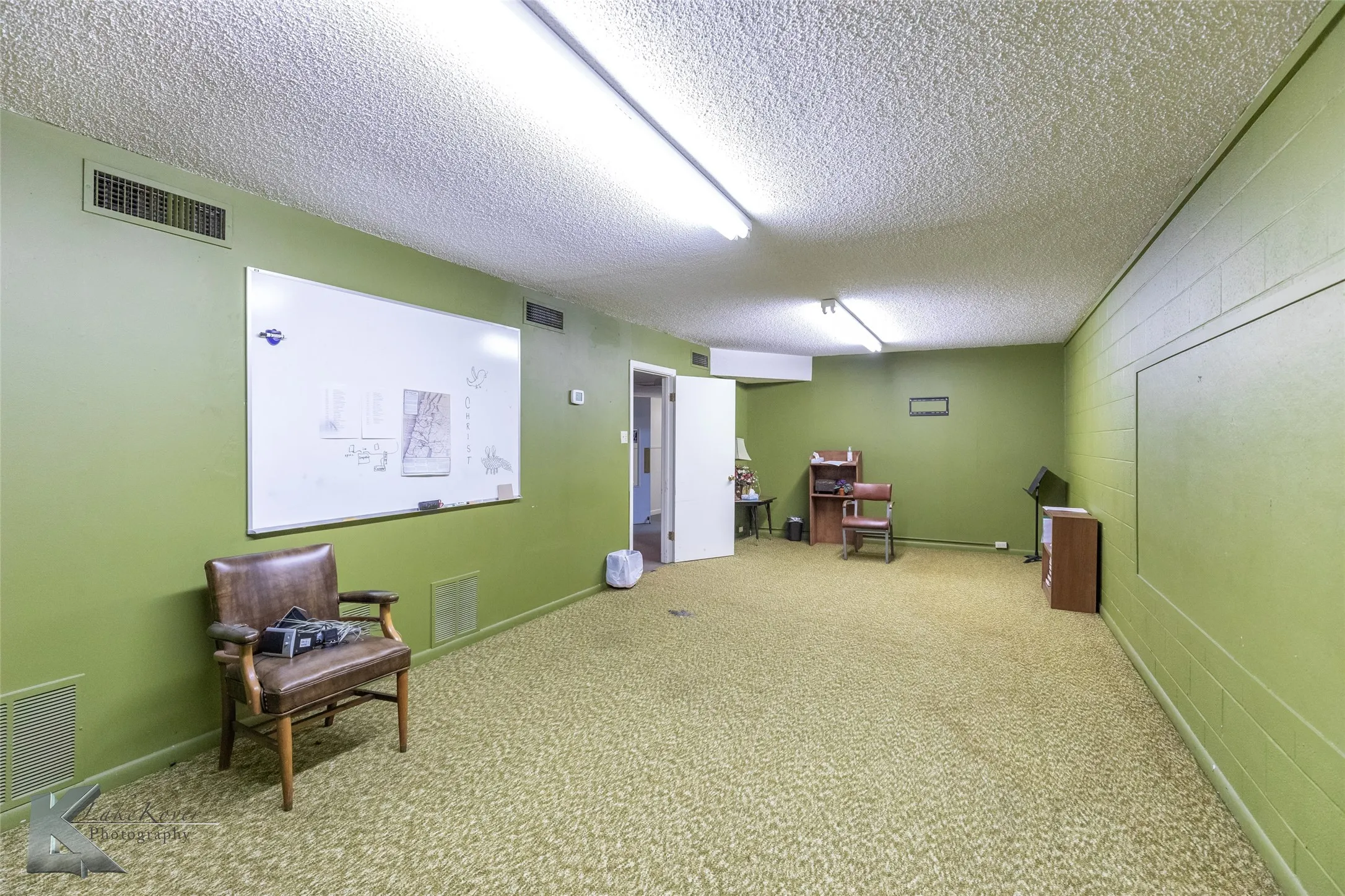 Sitting room with carpet floors and a textured ceiling