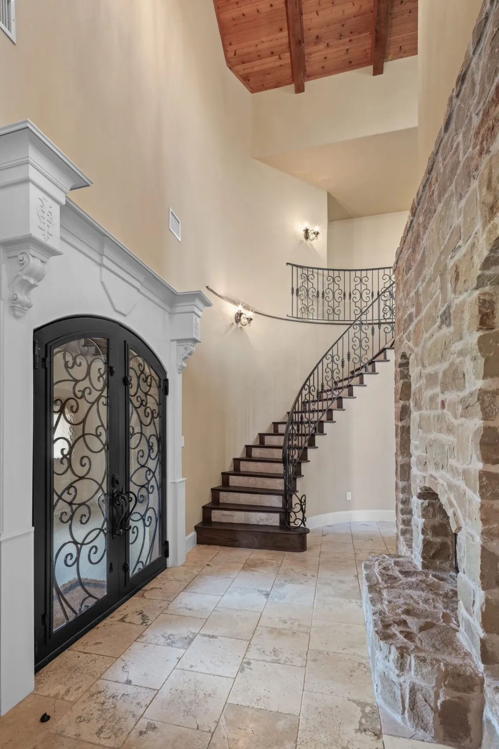From the moment you enter through the grand iron-accented doors, every detail whispers luxury. Vaulted ceilings, three glowing fireplaces, and handcrafted ironwork speak to artisan design, while the flowing layout offers both grace and grandeur.