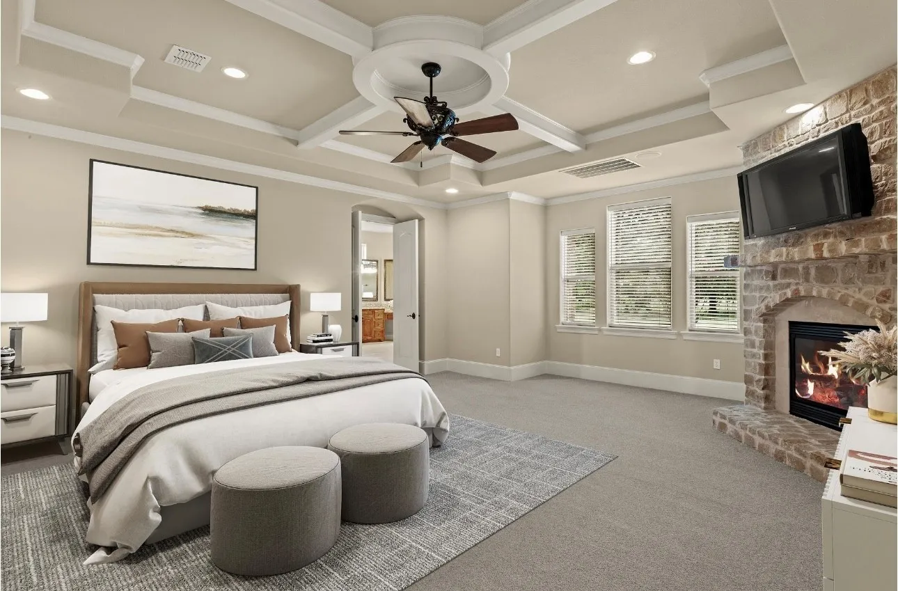 Retreat to the serene elegance of the owner’s bedroom, where timeless Tuscan-inspired design meets modern comfort. A cozy gas fireplace set in a rustic stone surround adds warmth and charm, while the stunning coffered ceiling with detailed trim work draws the eye and enhances the architectural sophistication. Brand-new plush carpeting provides a fresh and inviting feel underfoot, and the suite flows effortlessly into a luxurious spa-style ensuite bath—creating a private sanctuary designed for true relaxation. This photo has been virtually staged.