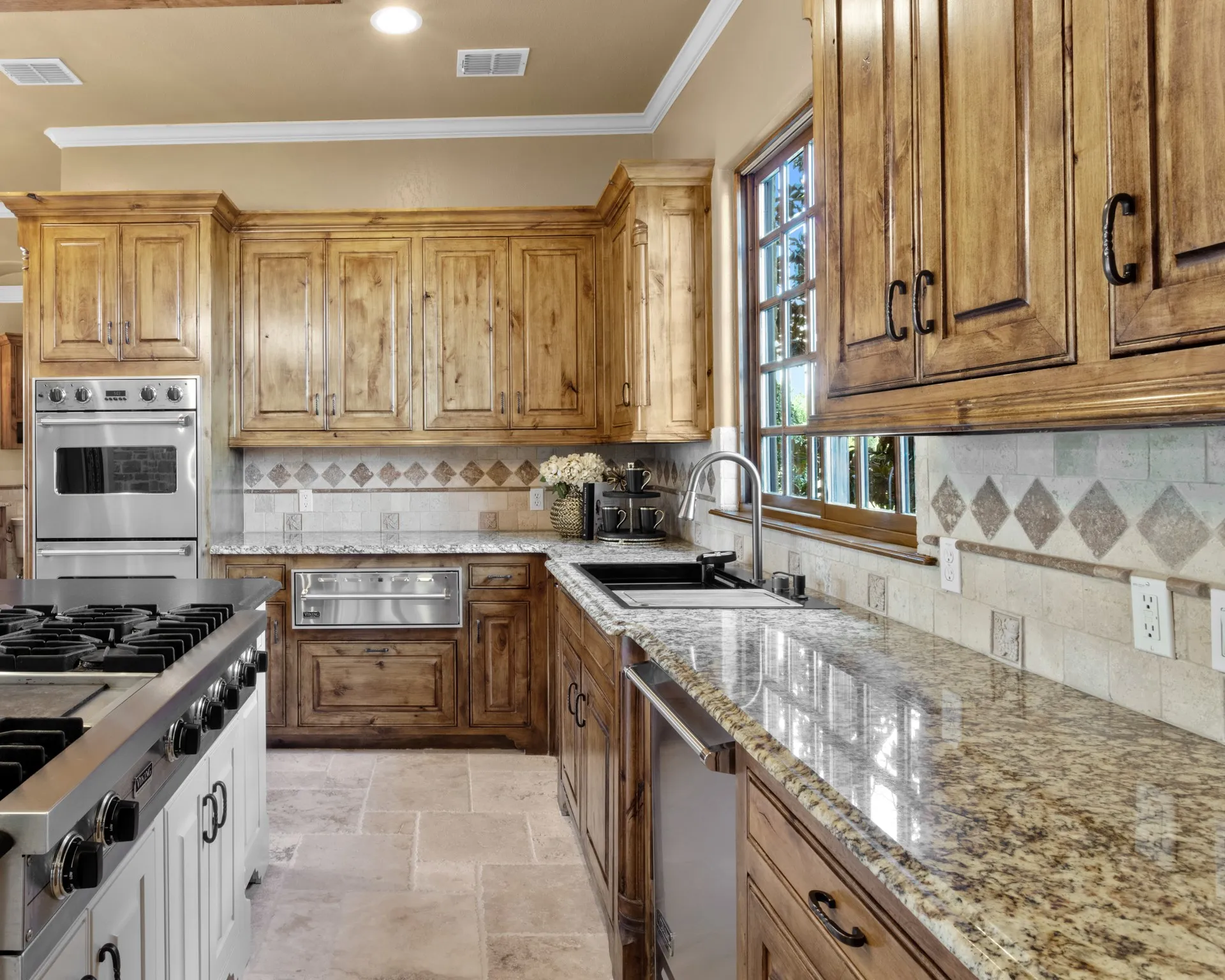 This stunning view of the kitchen unveils a true culinary masterpiece, outfitted with an impressive suite of professional-grade appliances, including a powerful 6-burner commercial gas range with integrated griddle—perfect for crafting everything from gourmet breakfasts to multi-course meals. A newly installed, designer sink adds both style and functionality, while the thoughtfully curated layout ensures that every element is within reach for seamless preparation. Discerning chefs will find inspiration in the high-end finishes and exceptional tools designed to elevate every culinary experience.