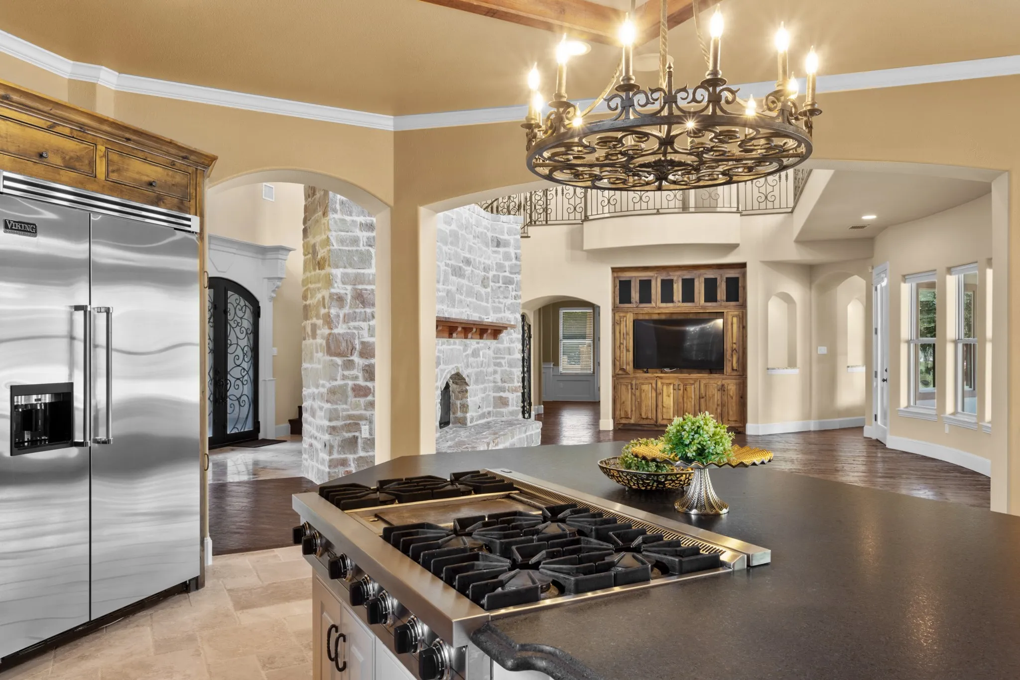 A true culinary treasure, this open-concept chef’s kitchen seamlessly connects to the inviting family room, ensuring the chef is always part of the conversation. Anchored by a professional-grade six-burner Viking range, the space is outfitted with gleaming granite countertops, premium stainless steel appliances, and a built-in, commercial-quality refrigerator—combining style with performance. Whether preparing a gourmet meal or entertaining guests, this kitchen offers an elevated experience where function meets connection in the heart of the home.