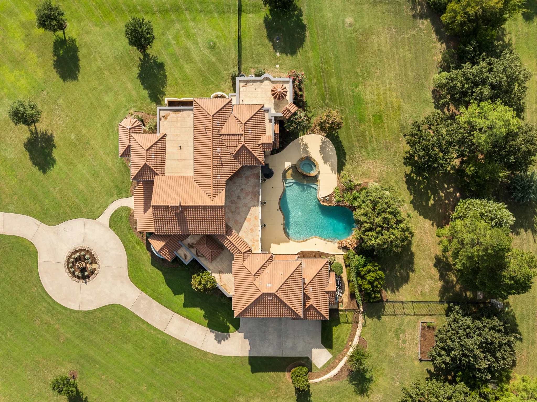 Welcome to this 6,638 square foot Tuscan-inspired estate, a true retreat nestled on over 2 acres of beautifully manicured grounds in the prestigious, gated community of The Landing in Flower Mound, Texas. From the moment you arrive, the governor’s drive and lush landscaping with mature trees set the tone for timeless elegance and privacy. The home’s classic tile roof, sweeping architecture, and serene setting create a resort-like ambiance—offering a rare blend of grandeur, comfort, and seclusion in one of Flower Mound’s most sought-after neighborhoods.