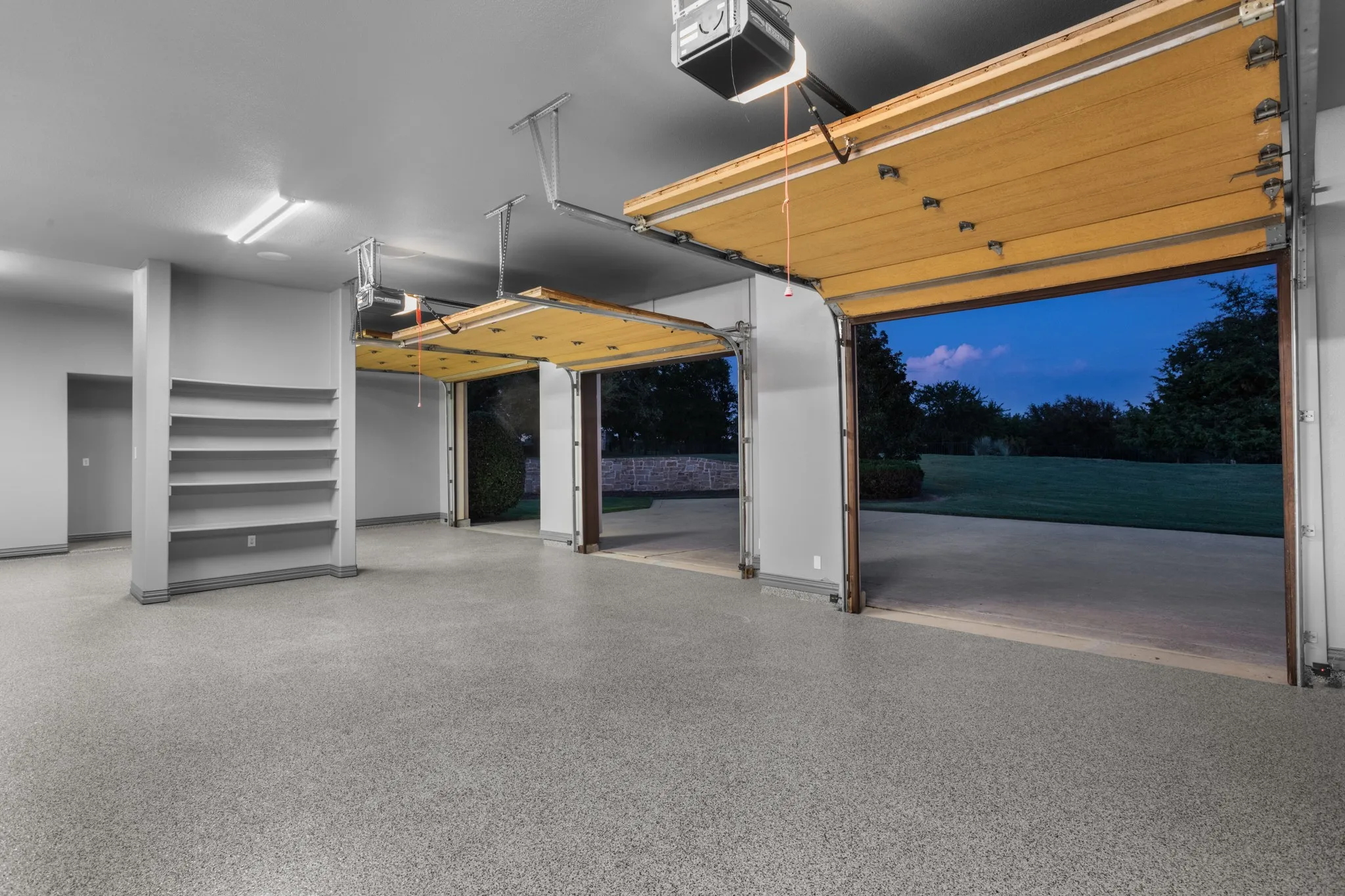Pristine Function Meets Luxury Design
This oversized 3-car side-entry garage is as refined as it is functional, featuring beautiful cedar doors, brand new epoxy flooring, and a dedicated storage center ideal for tools, sports equipment, or hobby gear. Designed for both daily convenience and high-end appeal, the garage provides seamless access to the estate’s spacious driveway while offering ample room for large vehicles and additional workspace. It's the perfect finishing touch to a home that balances luxury and livability at every turn.