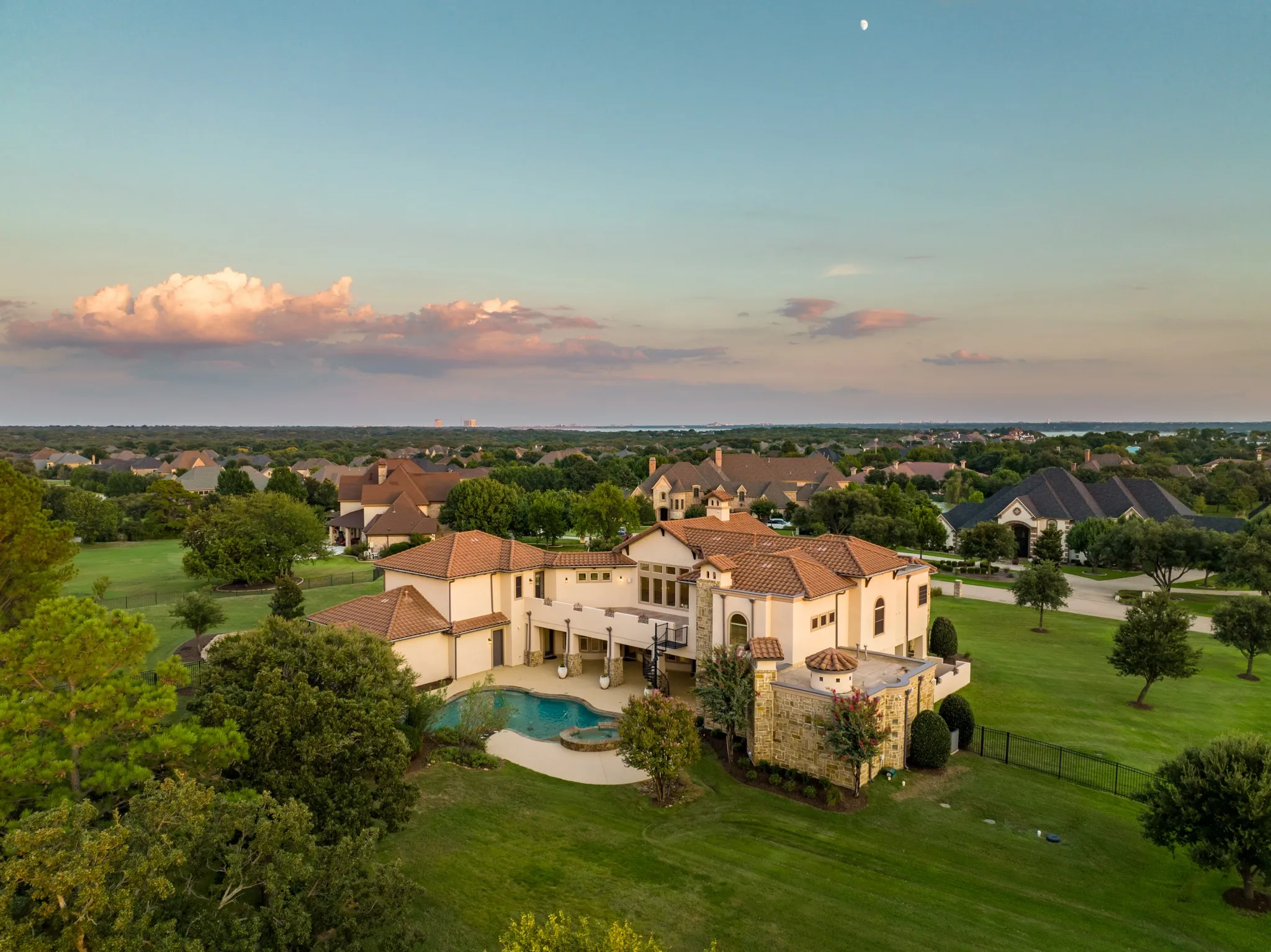 Step into your own private oasis—this breathtaking backyard retreat is the crown jewel of a multi-million dollar estate. Nestled on over 2 meticulously manicured acres, the outdoor living space is designed for both grand entertaining and peaceful relaxation. A resort-style pool and spa invite you to unwind under the Texas sky, while the expansive terrace offers sweeping views of the lush grounds. The generous covered patio and extensive pool decking create the perfect setting for alfresco dining, sun-soaked lounging, or evening gatherings under the stars.