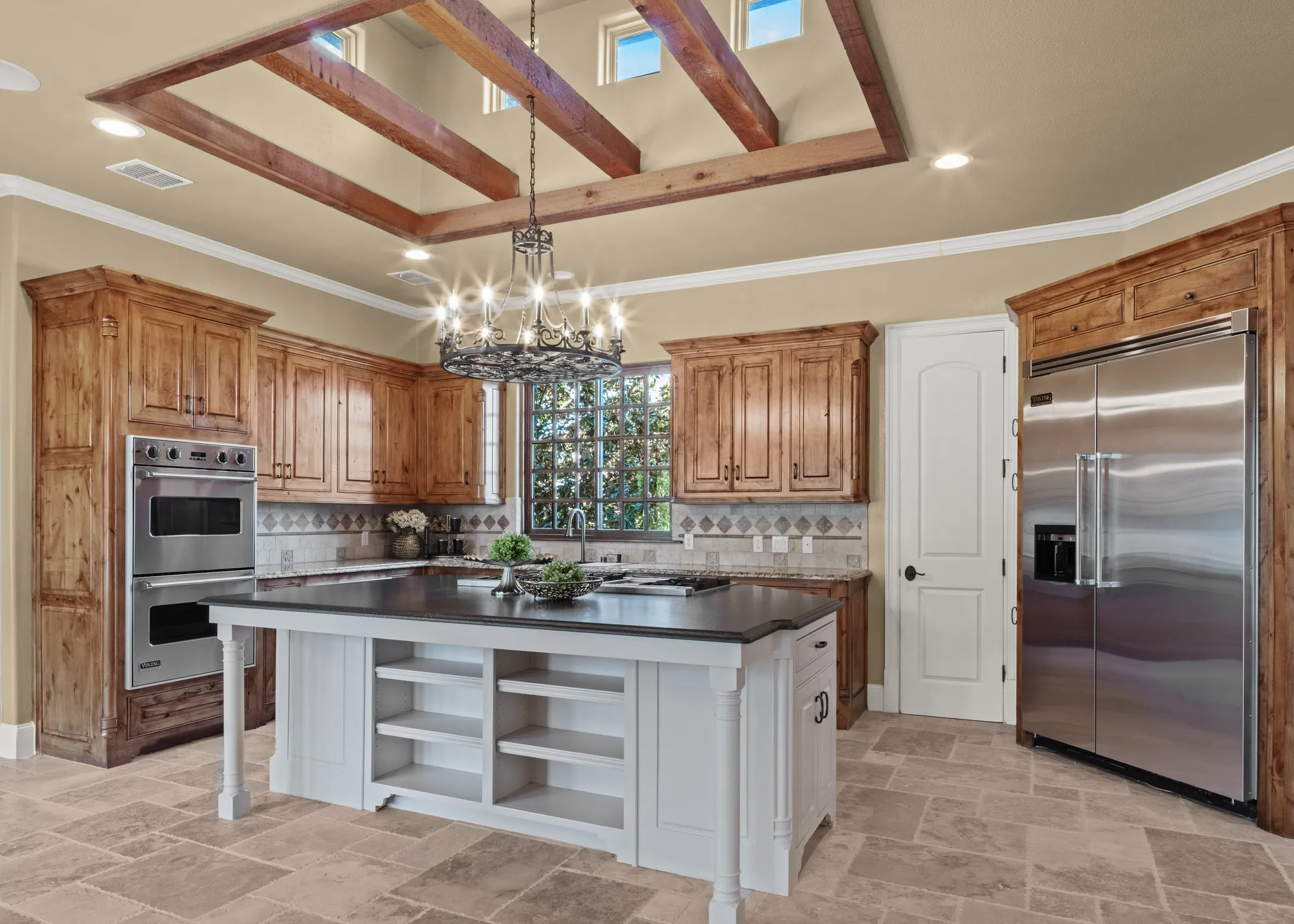 The heart of the home is a chef’s kitchen a masterpiece of form and function, boasting VIKING appliances, a 6-burner stove with griddle, granite countertops, and exquisite custom lighting. Whether you're preparing an intimate meal or hosting a grand soirée, every culinary detail is effortlessly elevated.