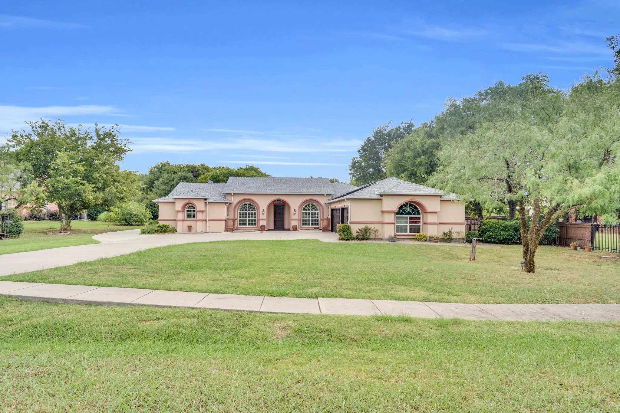 Mediterranean / spanish home with concrete driveway and stucco siding