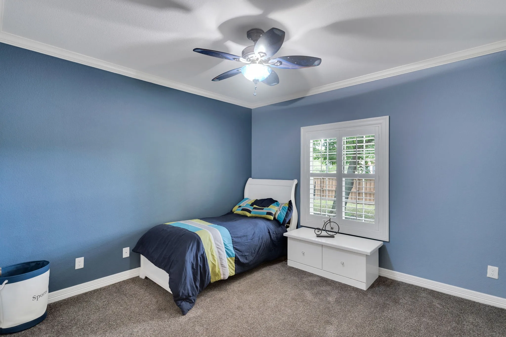 Bedroom featuring ornamental molding, carpet flooring, and a ceiling fan