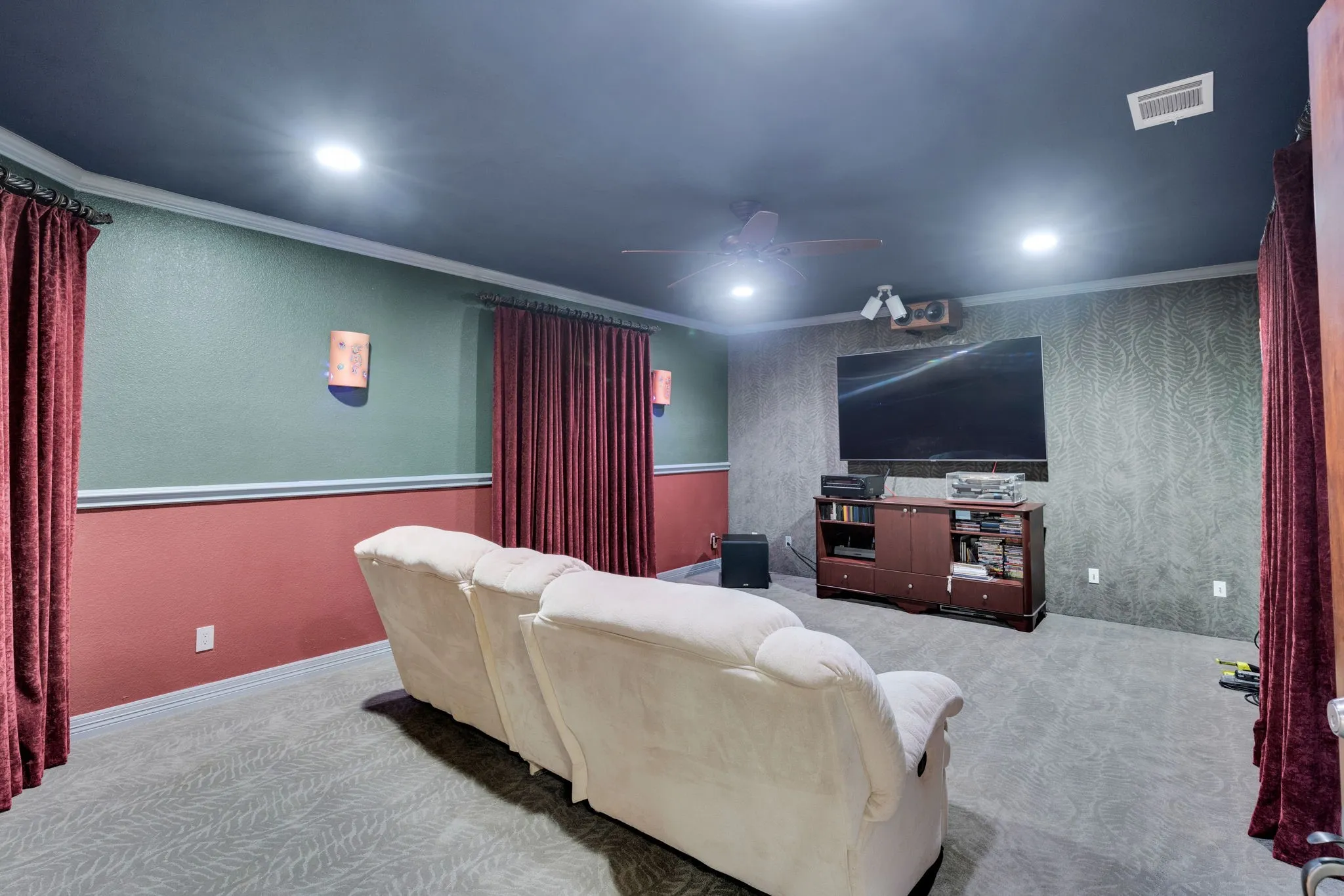 Carpeted cinema room featuring crown molding, a ceiling fan, and recessed lighting