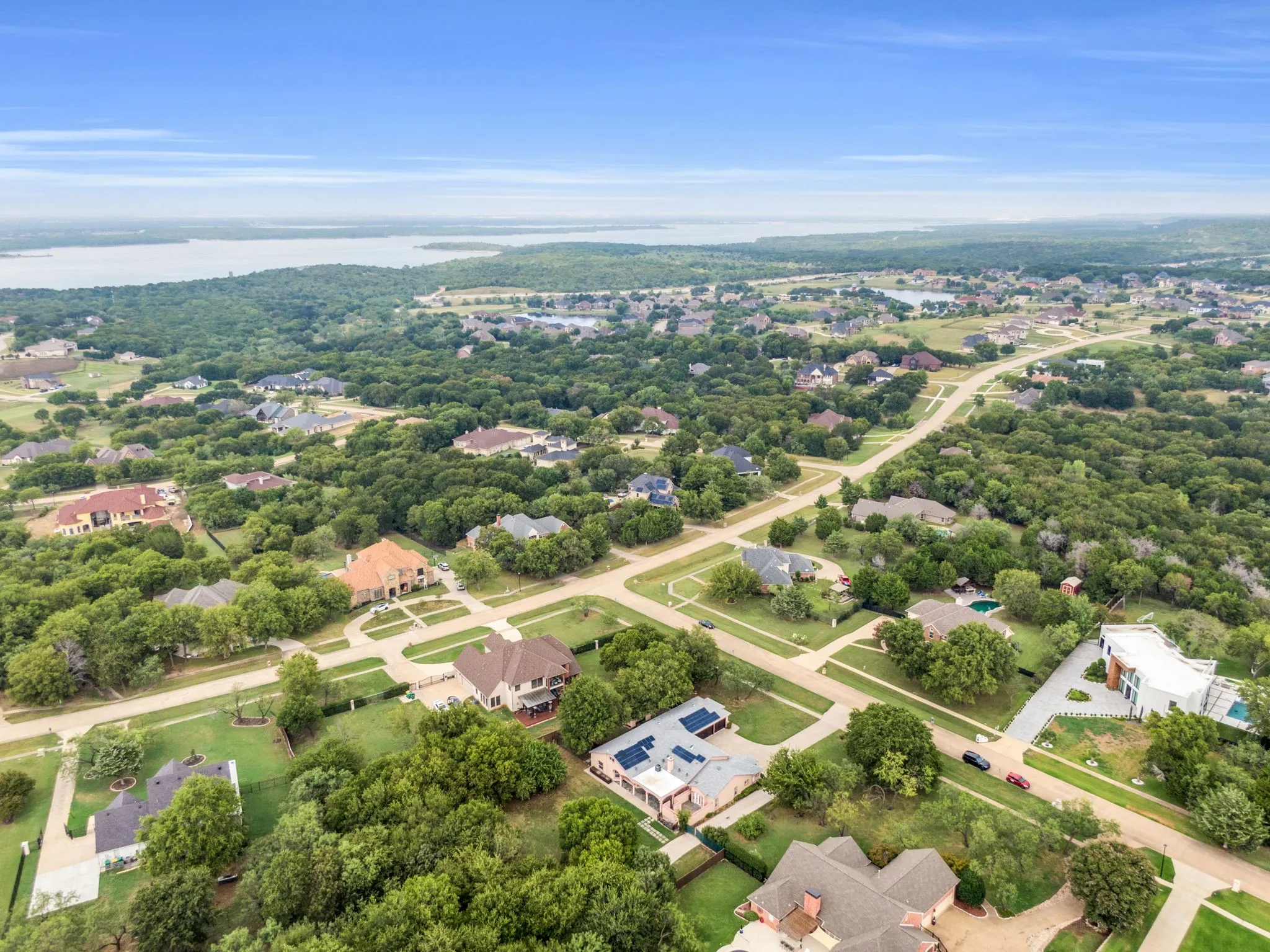 Aerial view of property's location featuring nearby suburban area and a large body of water