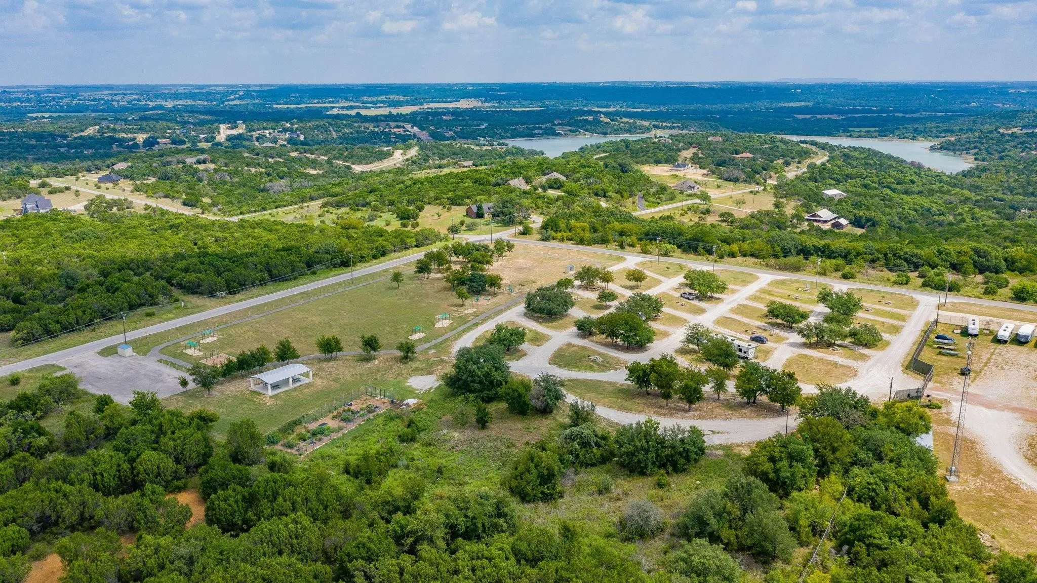 Drone / aerial view of a nearby body of water and a forest