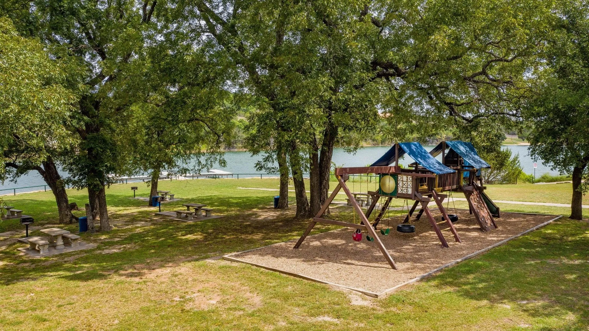 Community playground featuring a yard and a water view