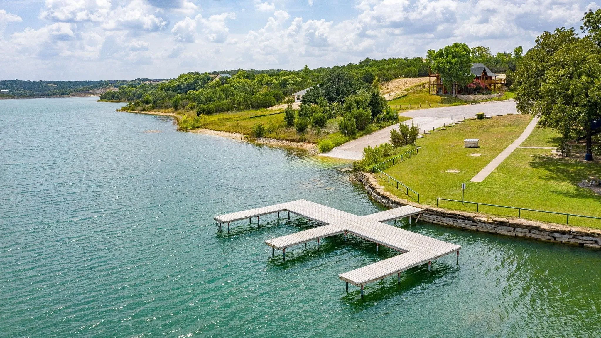 Dock featuring a water view and a yard
