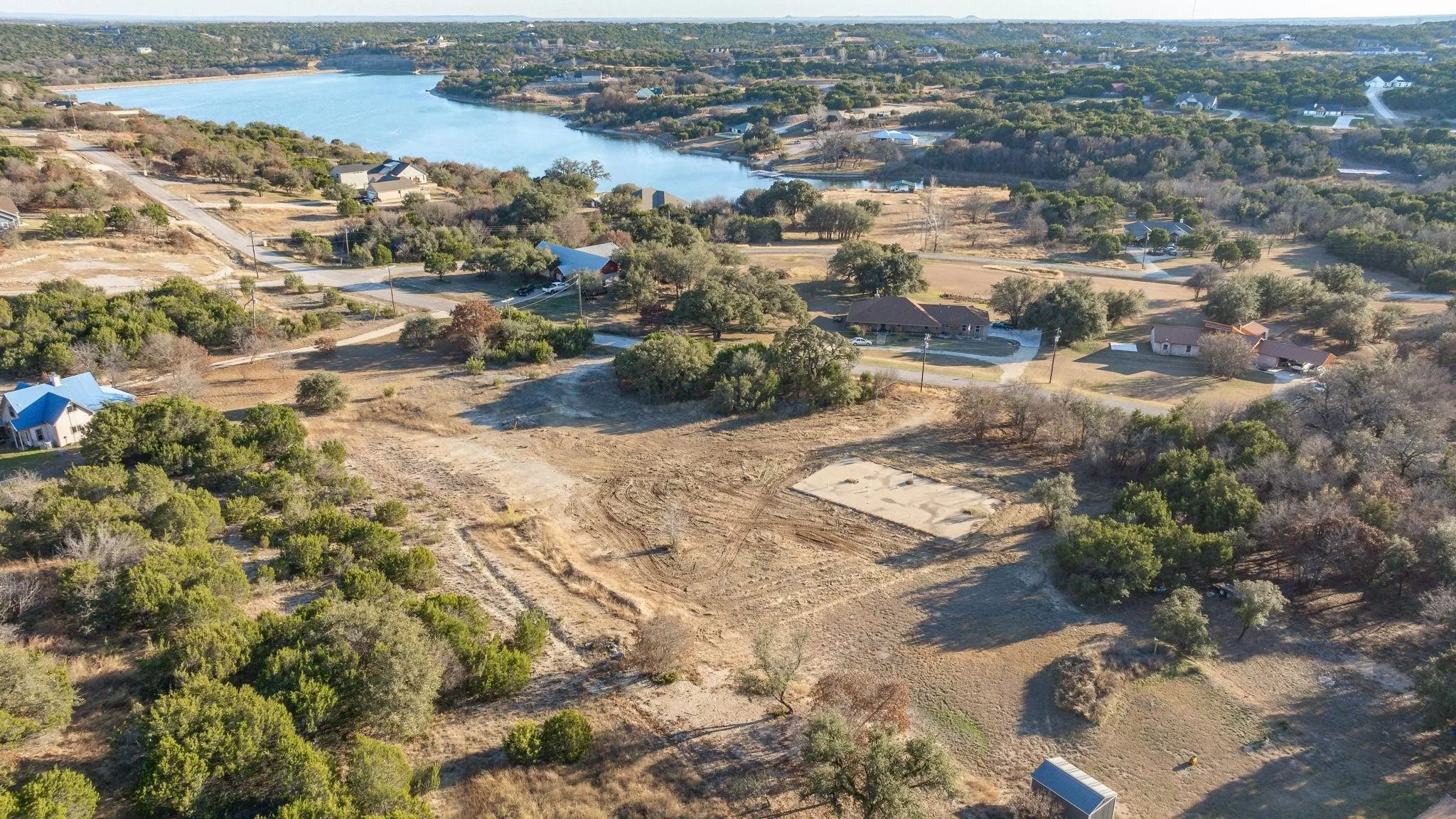 Aerial view of property's location with a large body of water