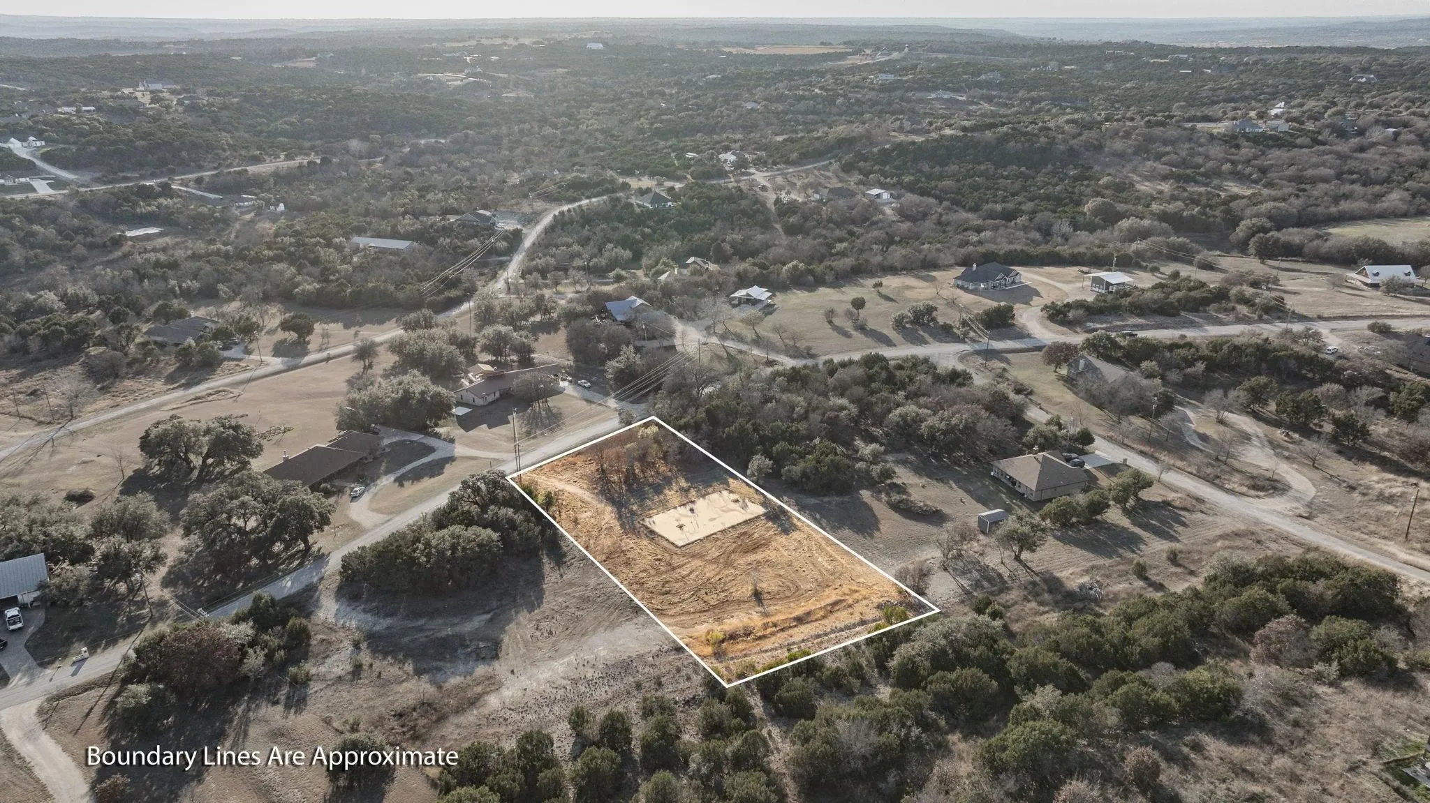 Aerial view of property and surrounding area with property parcel outlined and rural landscape