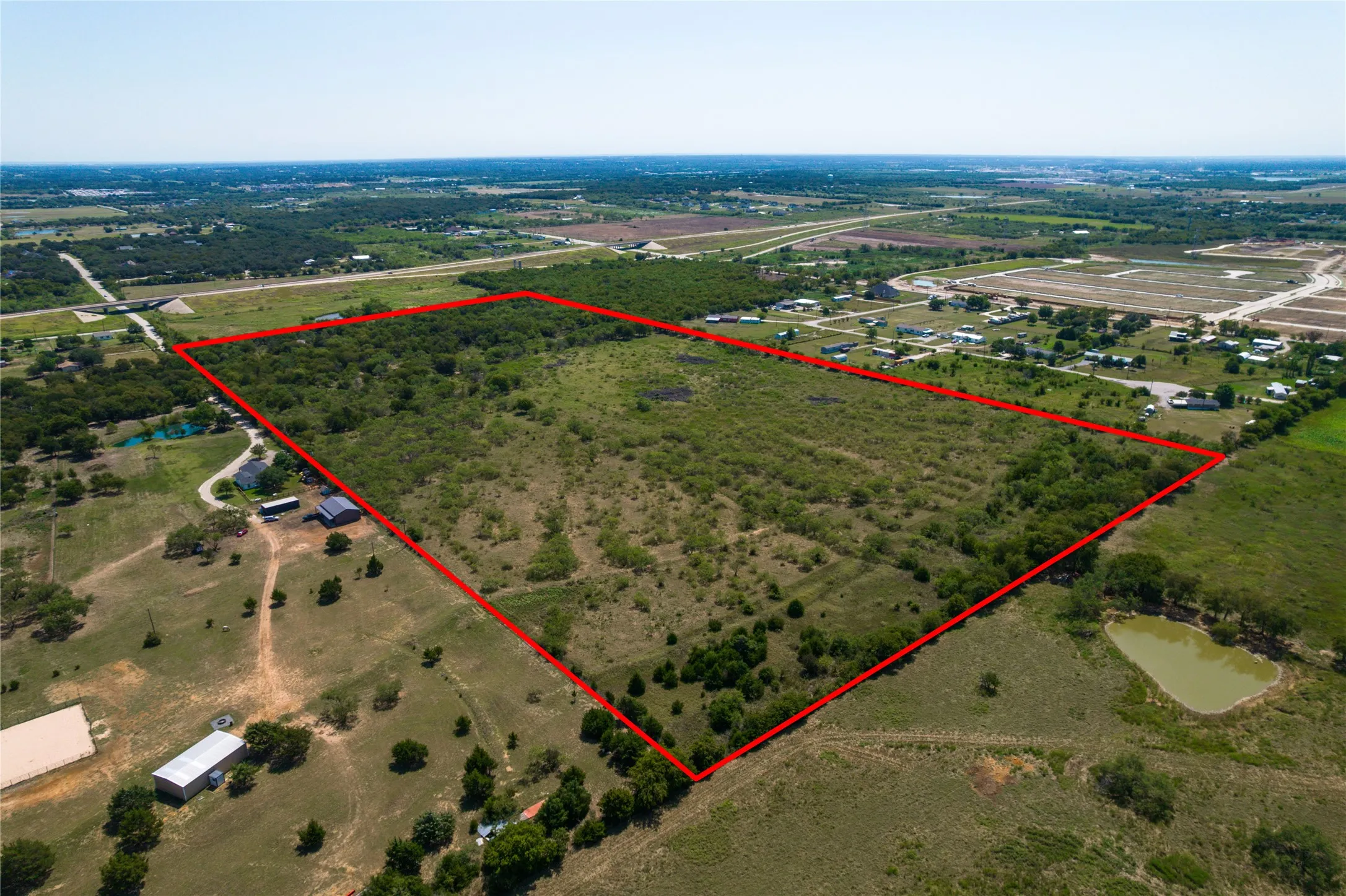 Aerial view of sparsely populated area with property boundaries highlighted