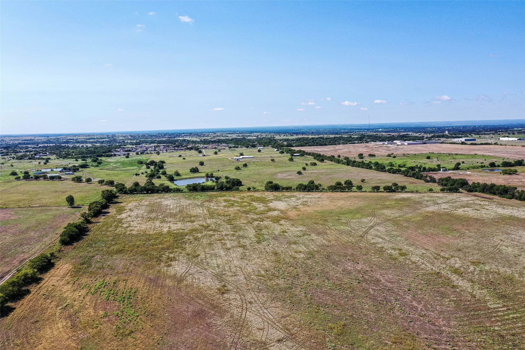Aerial view of sparsely populated area with a nearby body of water