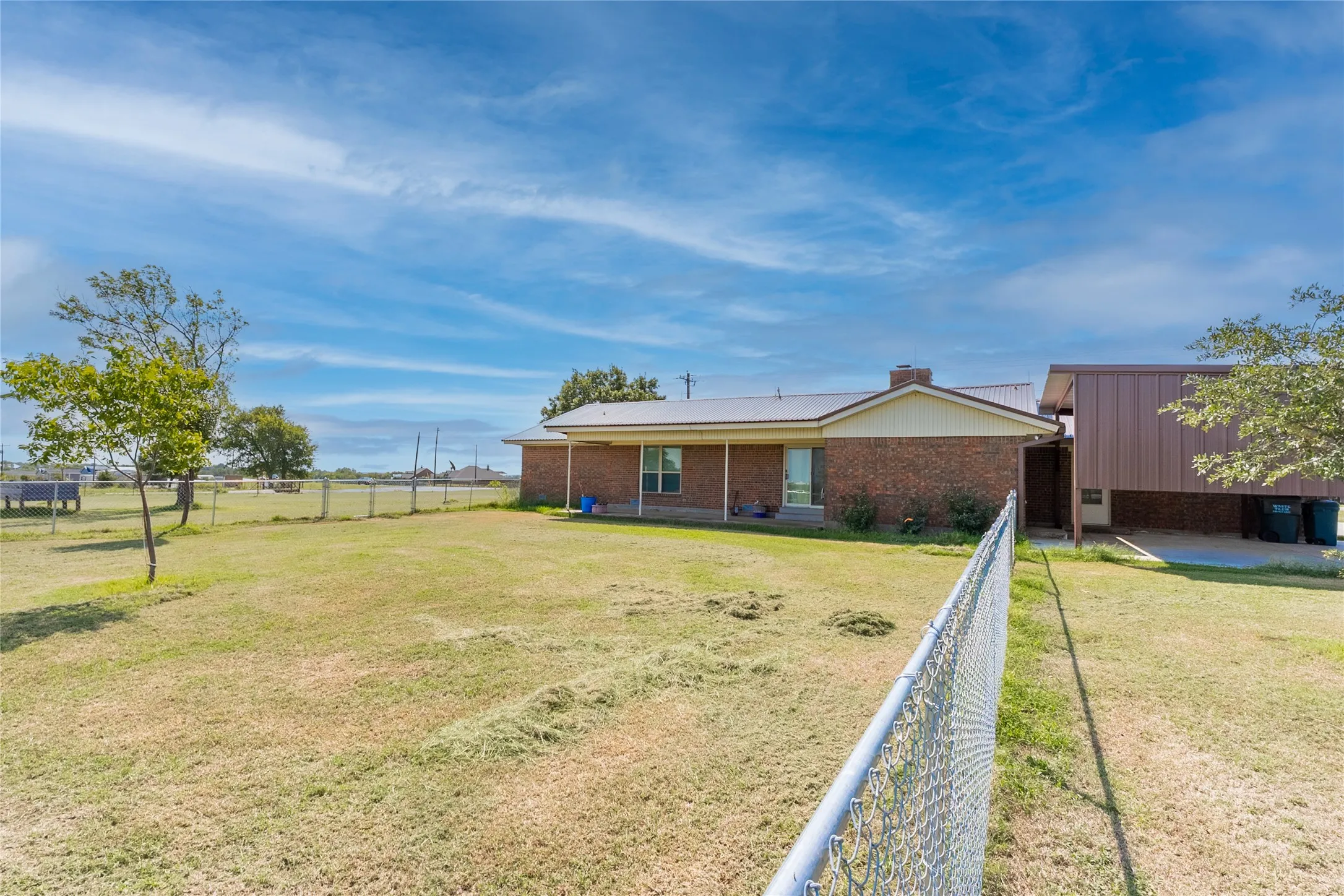Rear view of house with a patio and brick siding
