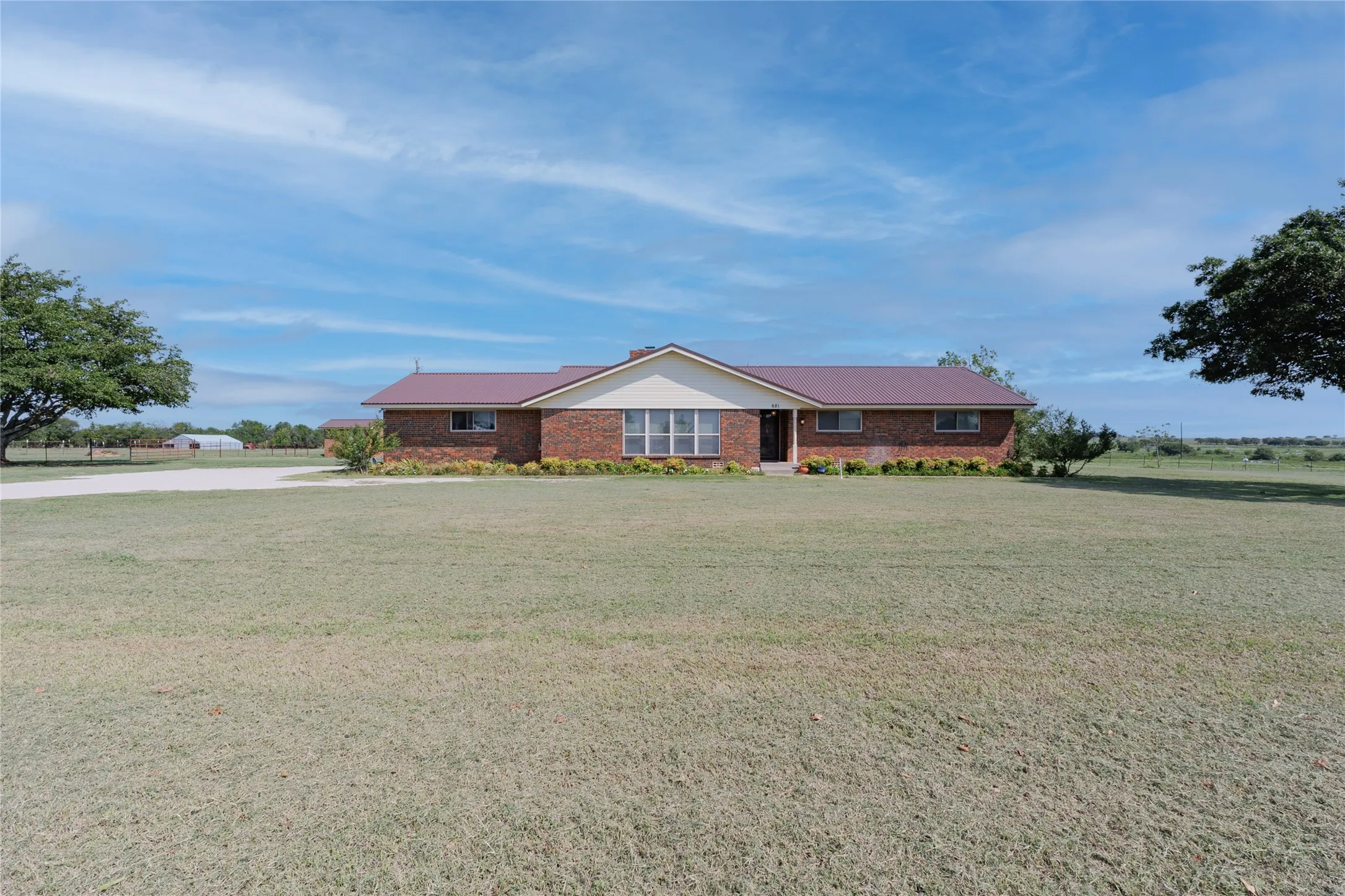 Single story home with a front lawn and brick siding