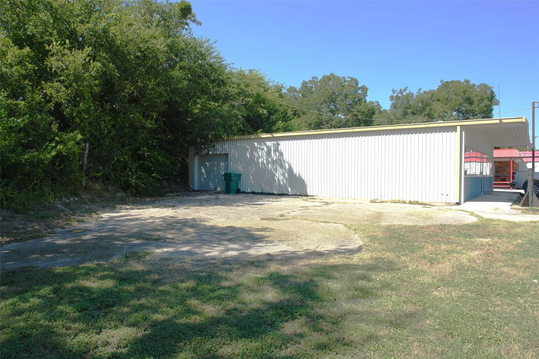 View of grassy yard with an outbuilding