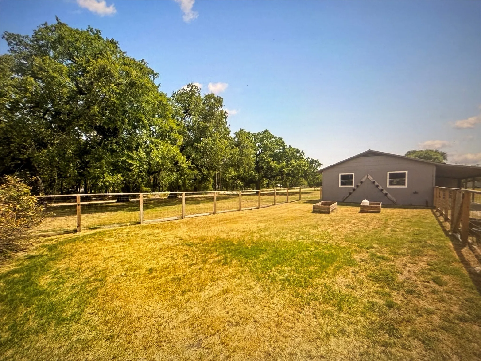 Fenced backyard featuring a view of countryside