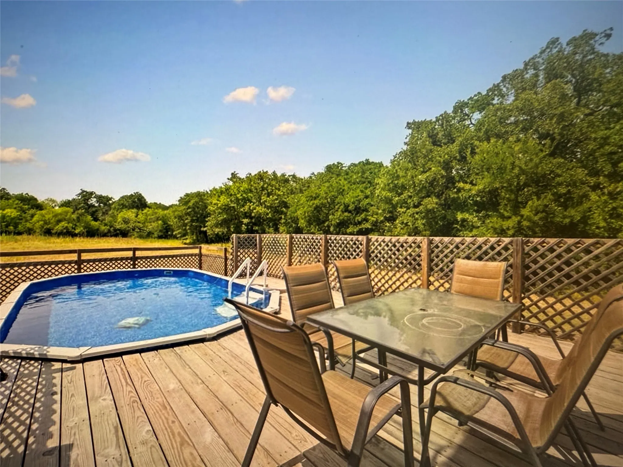 View of swimming pool featuring a deck and outdoor dining space