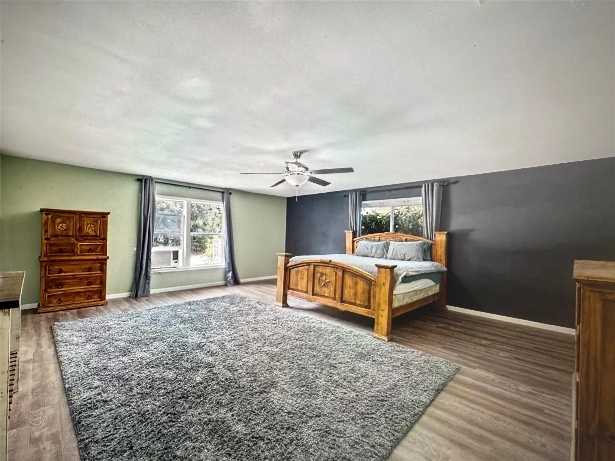 Bedroom with ceiling fan and wood finished floors