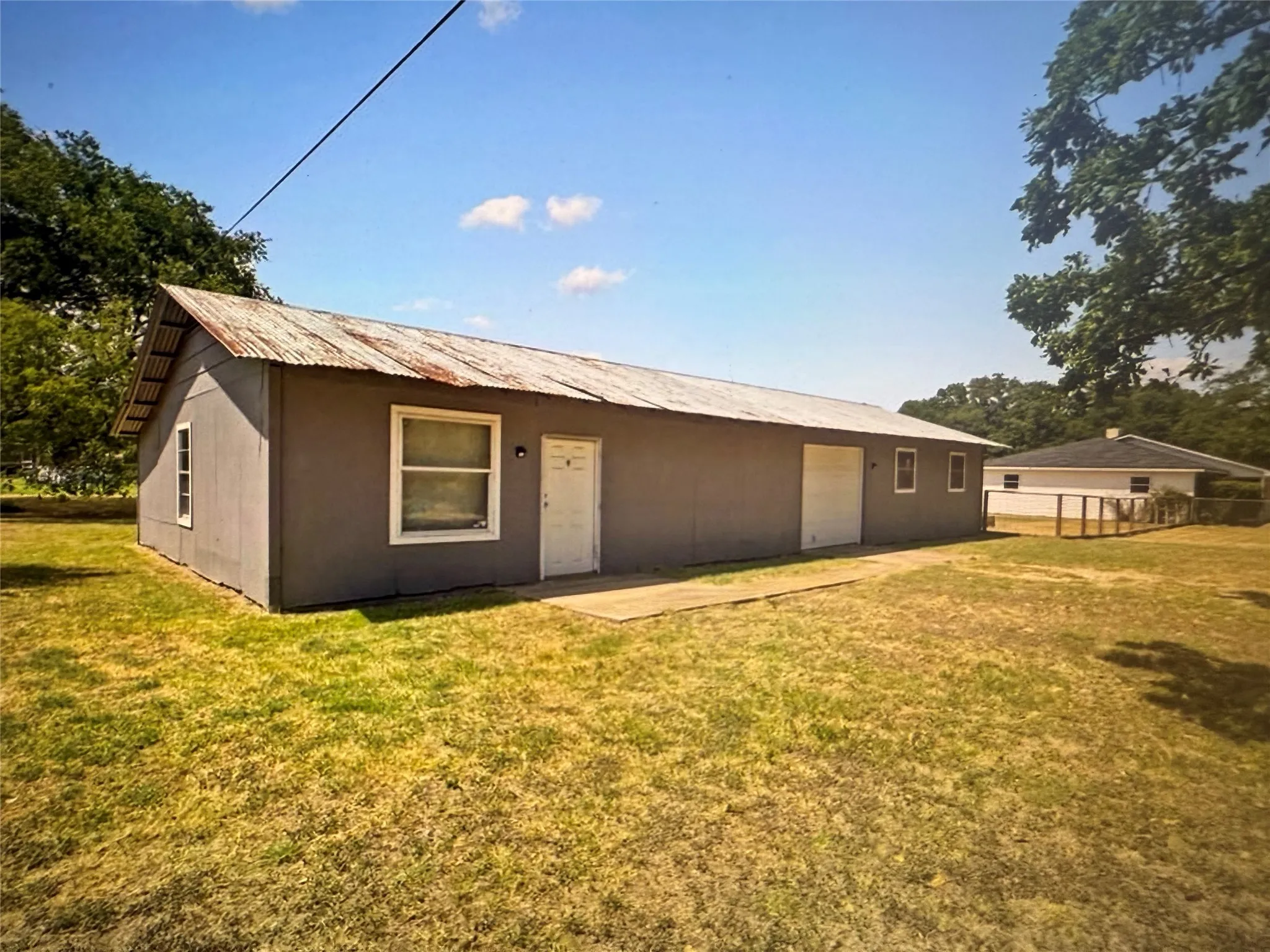 Back of house featuring a metal roof