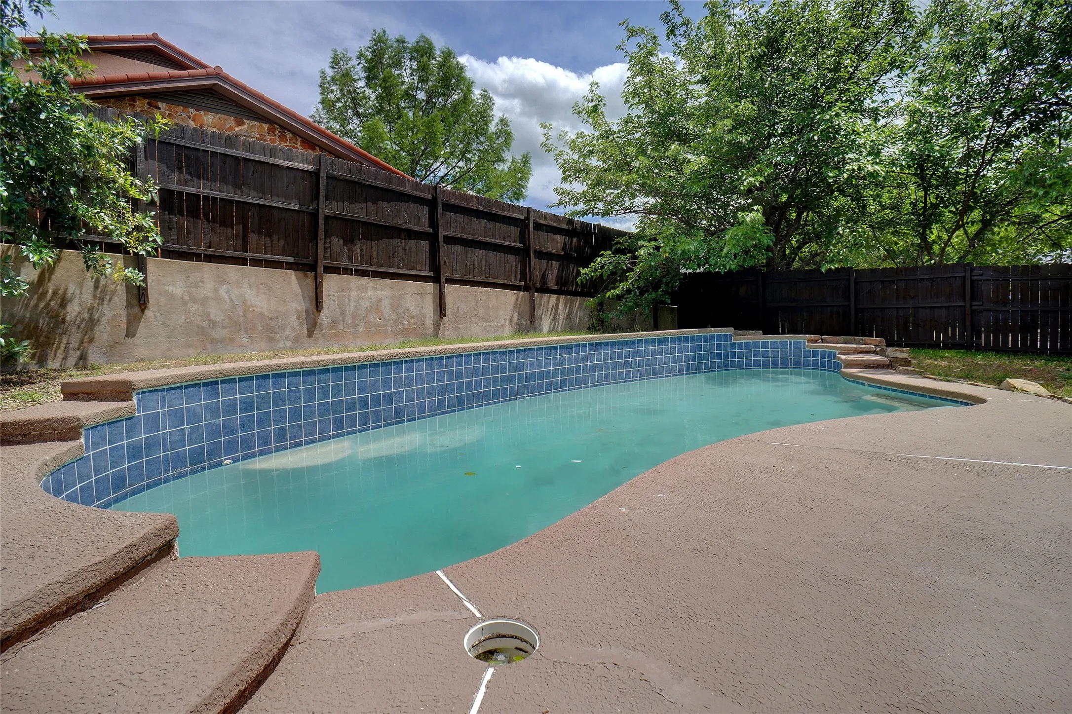 View of pool with a fenced backyard and a patio