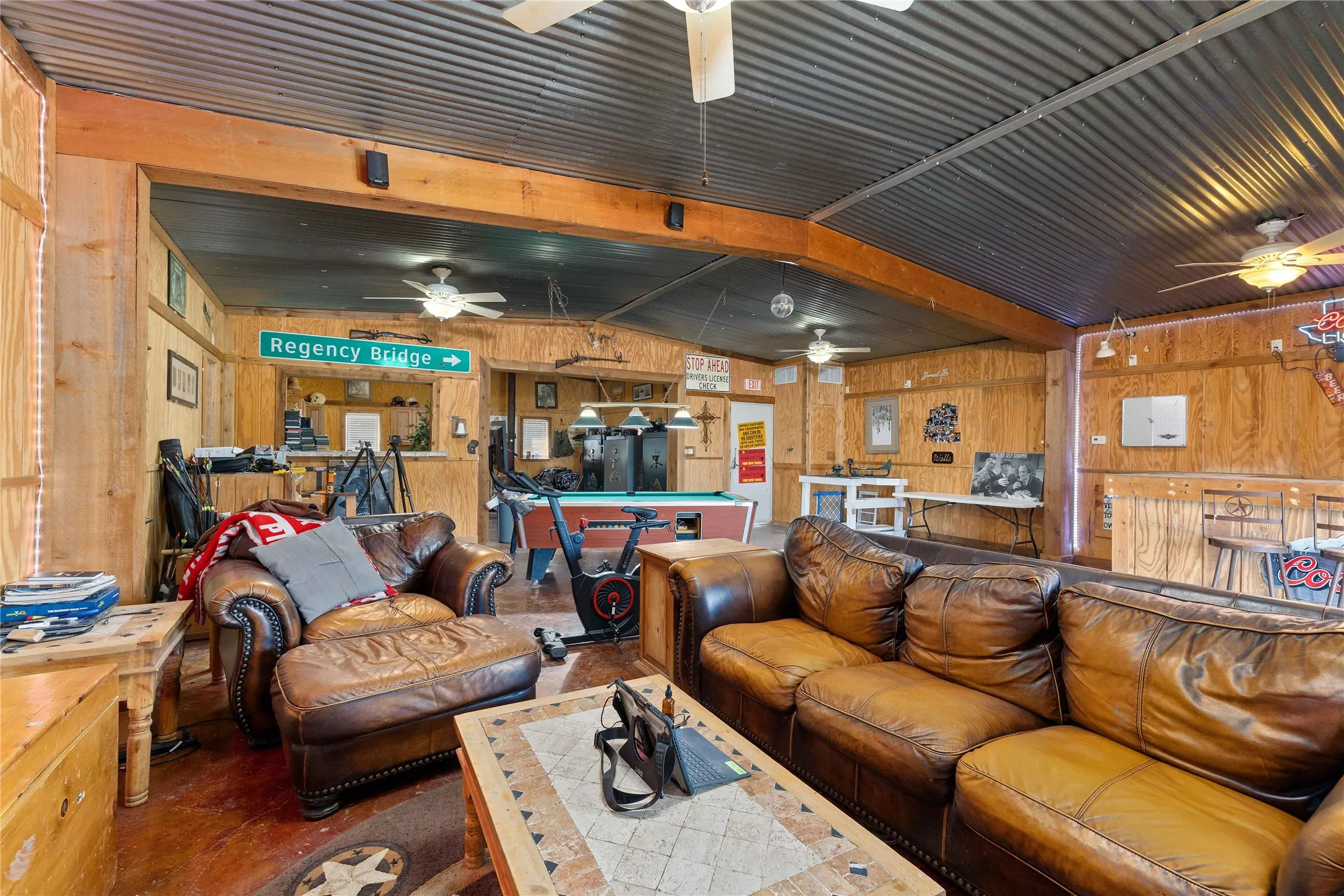 Living area with lofted ceiling, billiards, and wooden walls