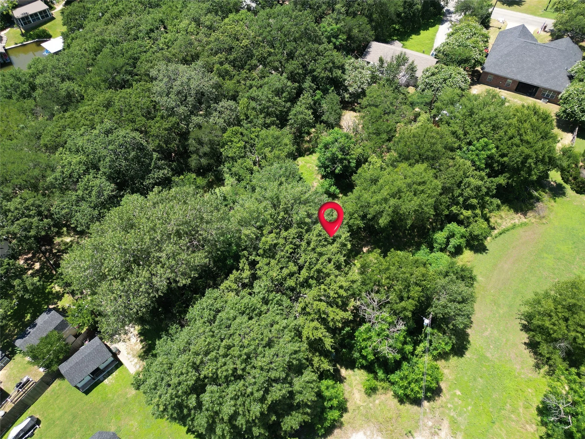 View of property location featuring a forest