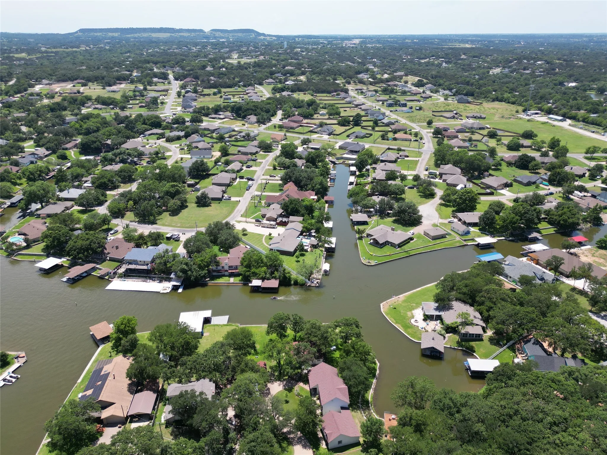 Aerial view of property's location featuring nearby suburban area and a large body of water