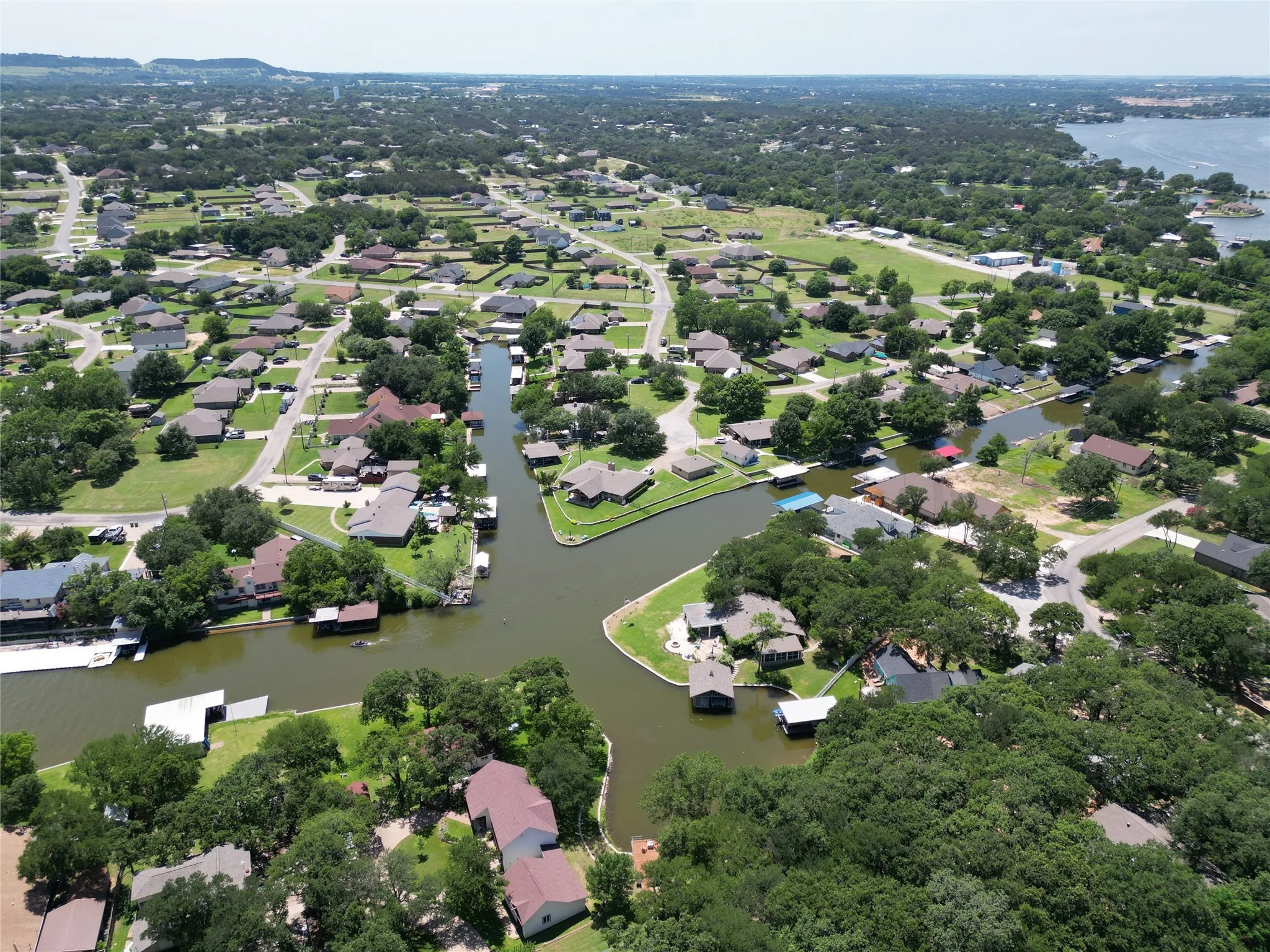 Aerial overview of property's location featuring a large body of water and nearby suburban area