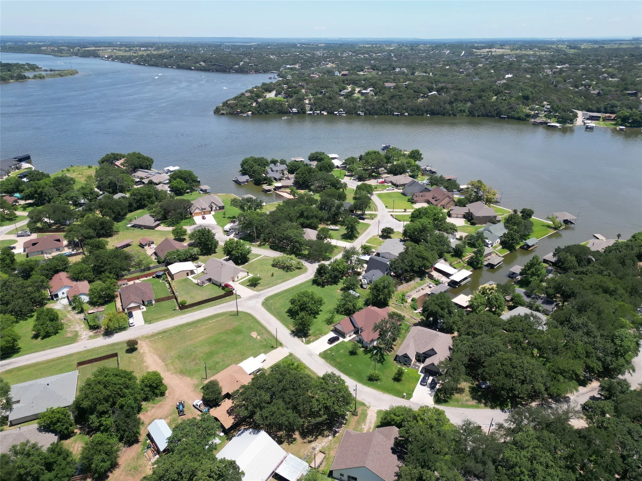 Aerial overview of property's location with nearby suburban area and a nearby body of water