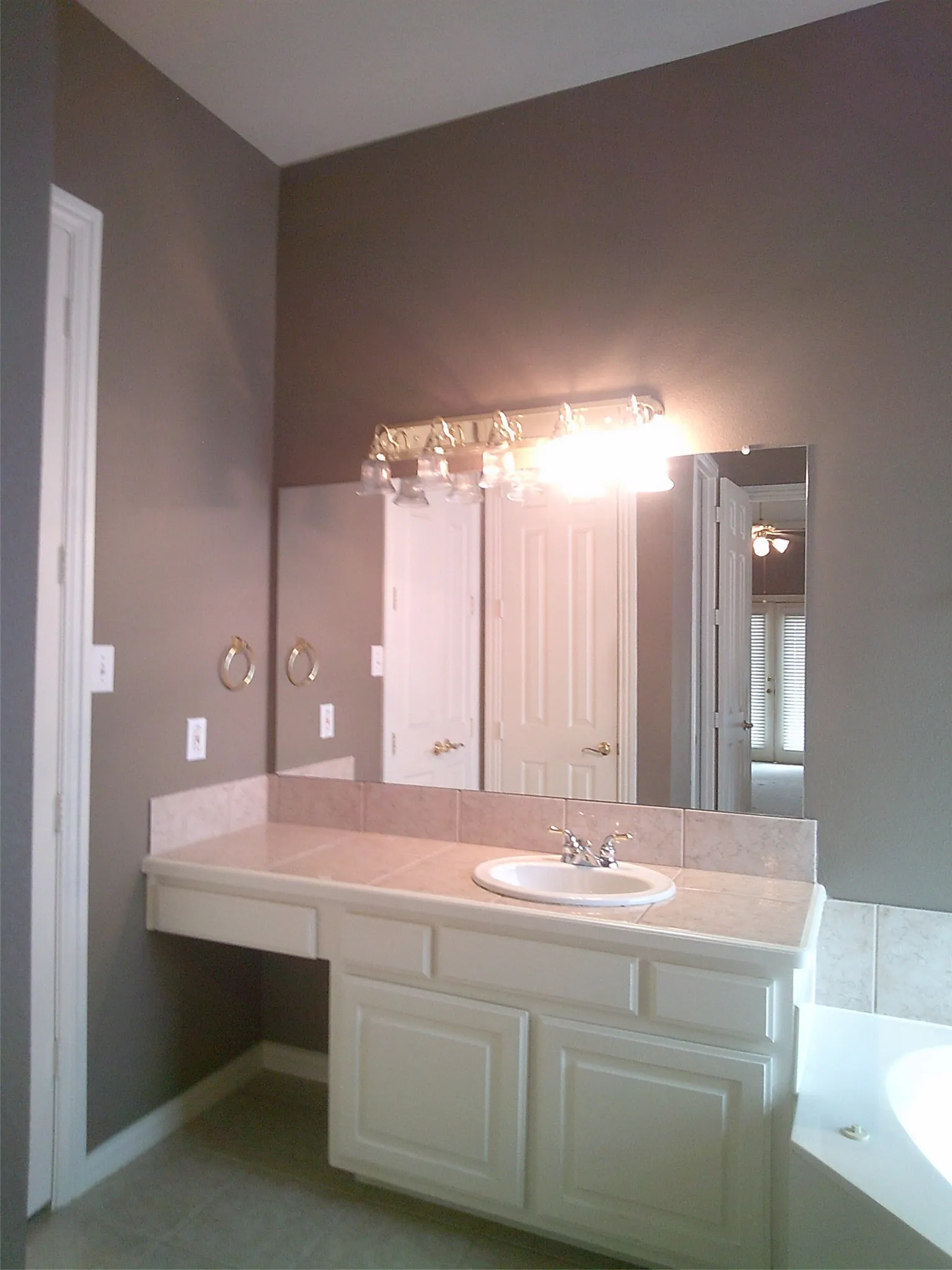 Bathroom featuring vanity and a garden tub