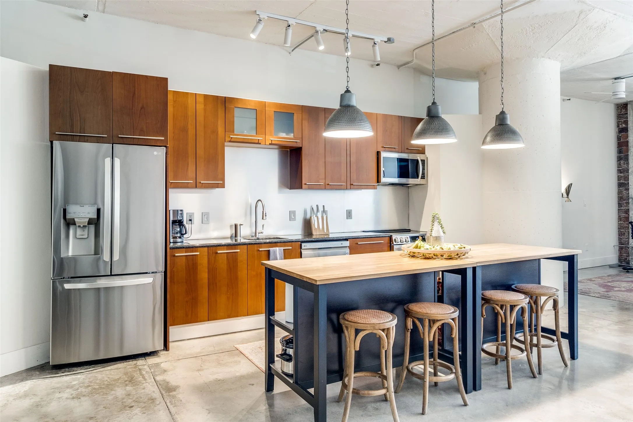 Kitchen with SS appliances, track lighting and kitchen island