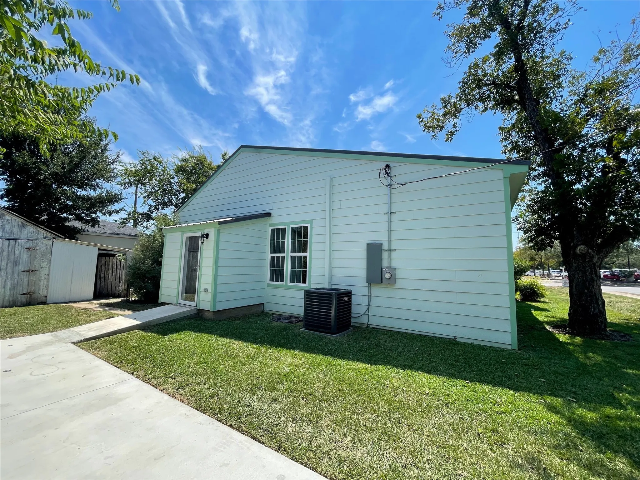 Back of property featuring a lawn