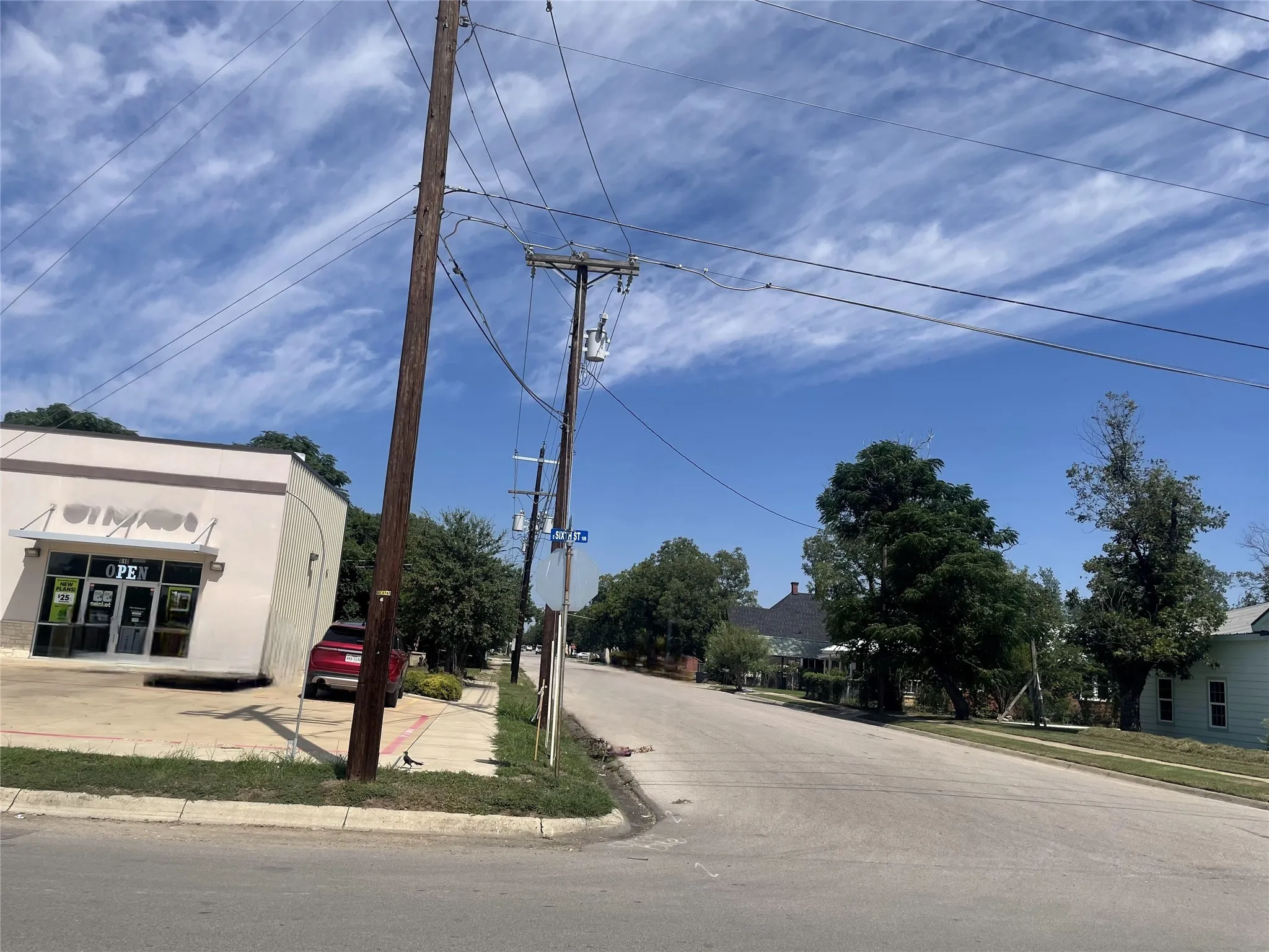 View of asphalt road with sidewalks and curbs