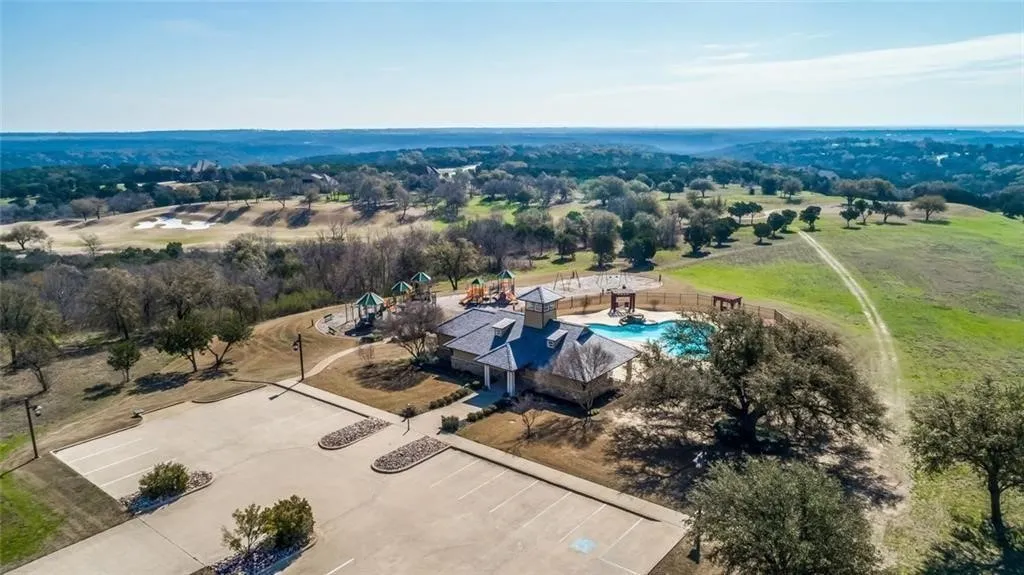 Aerial view of sparsely populated area with a pool