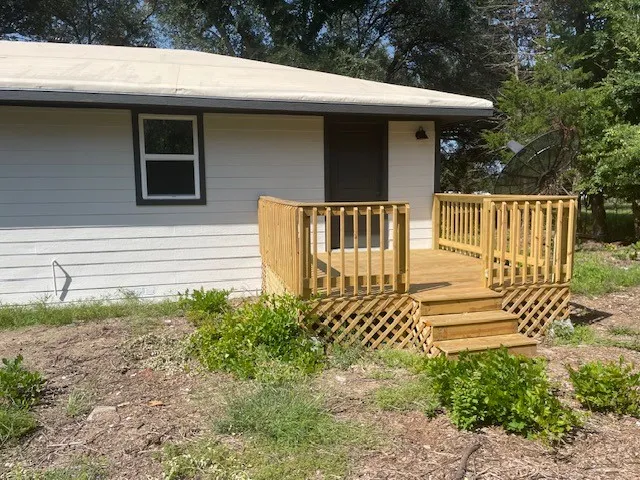 Property entrance with a wooden deck