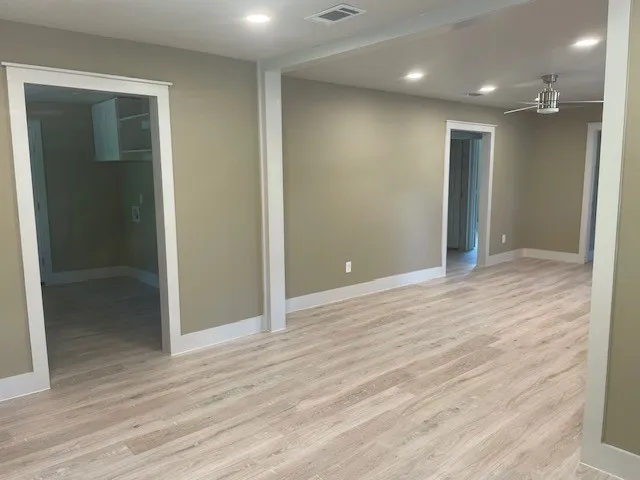 Spare room featuring light wood-style floors, recessed lighting, and a ceiling fan