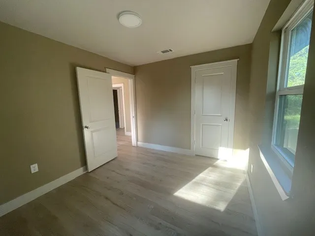 Unfurnished bedroom featuring baseboards and light wood finished floors