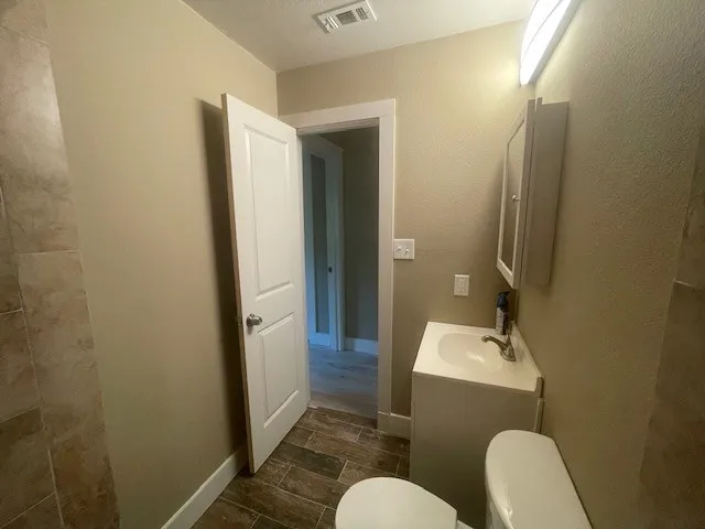 Bathroom with vanity and wood tiled floors