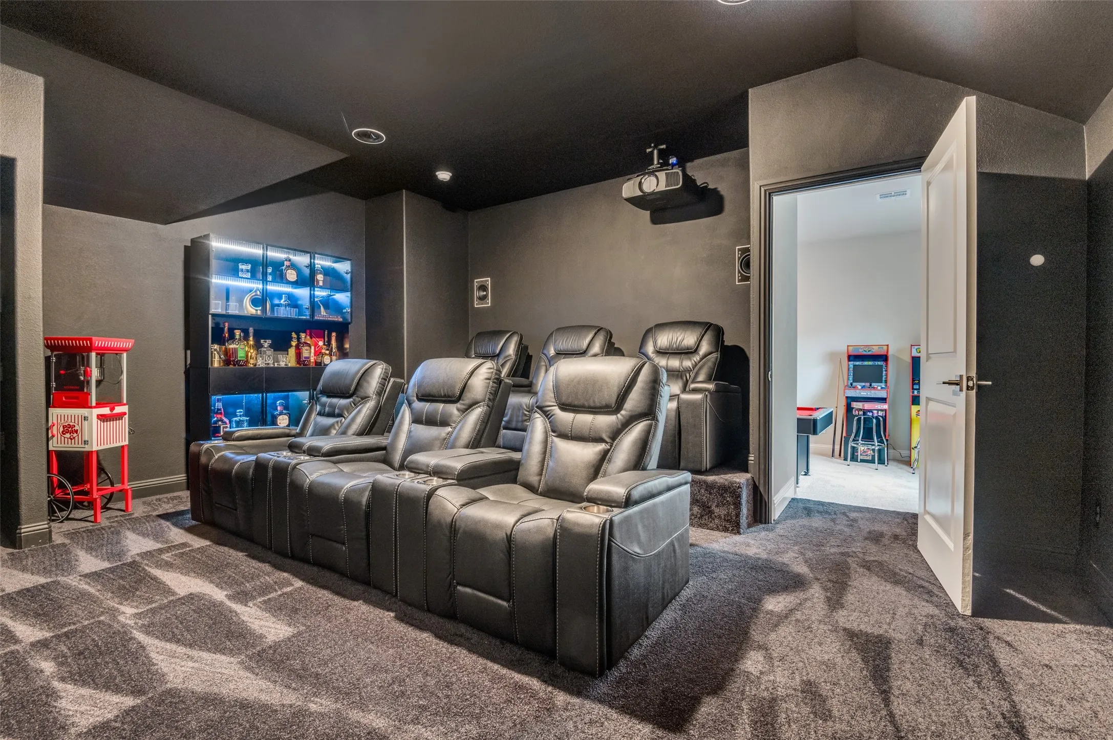 Carpeted cinema room with baseboards