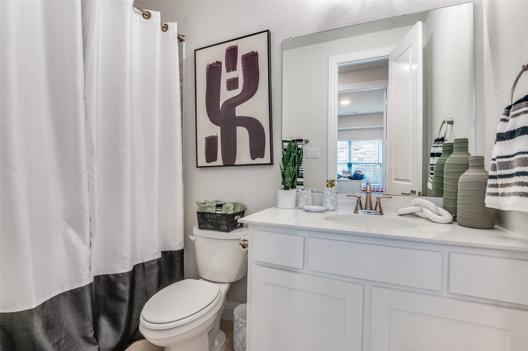 Bathroom with vanity and curtained shower